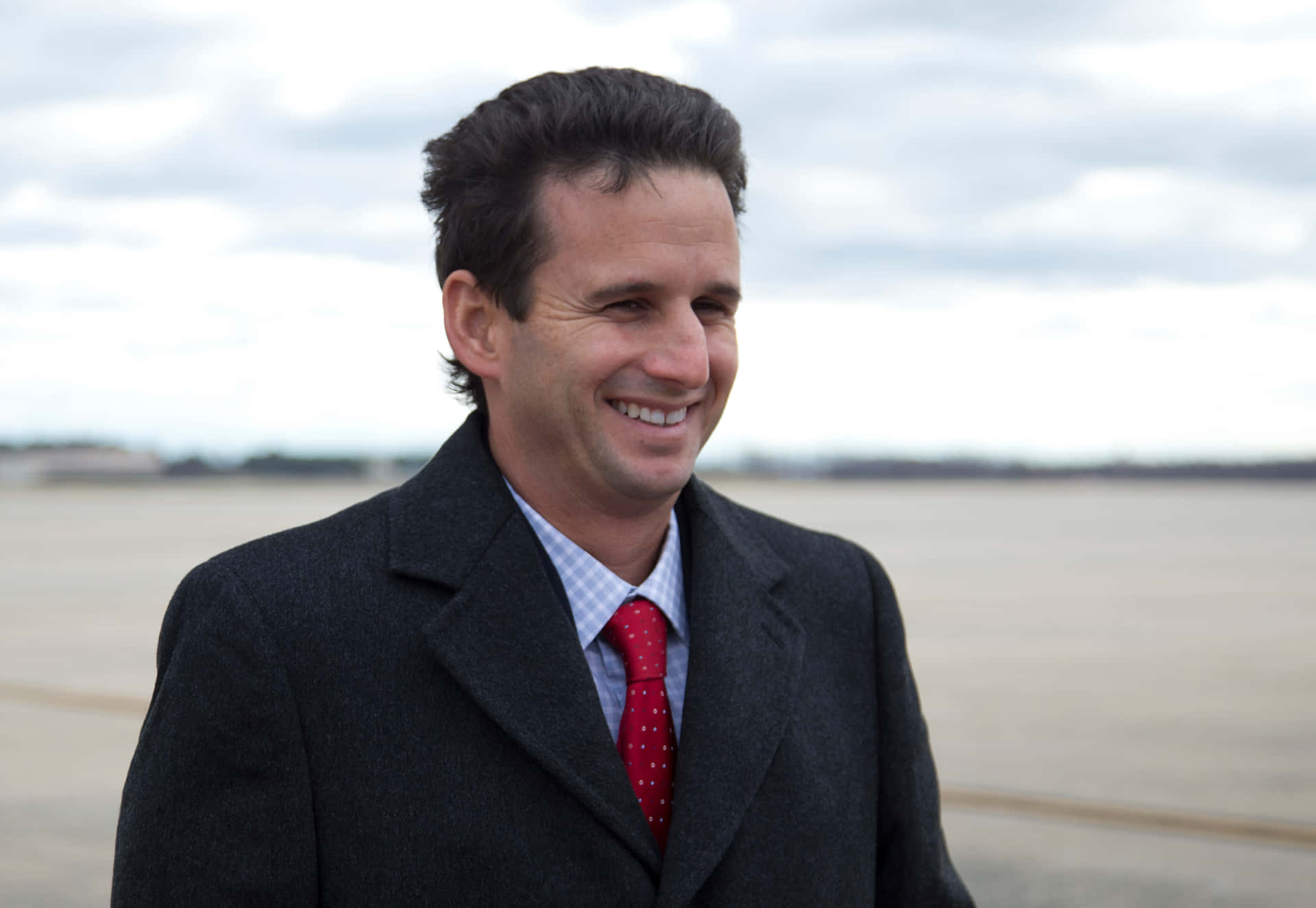 Brian Schatz Smiling On Beach Background
