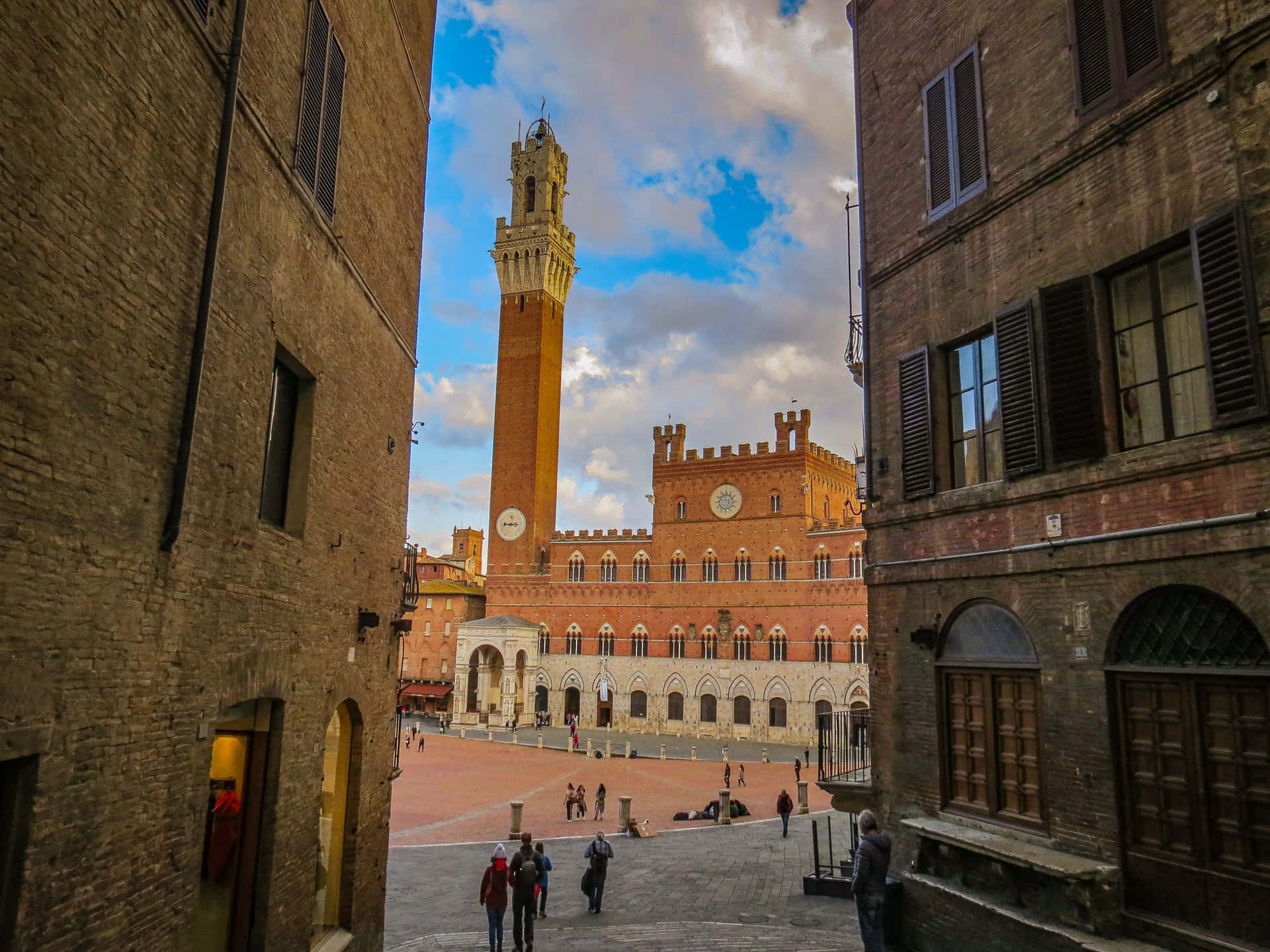 Brick Buildings And Tower Of Mangja In Siena Italy Background