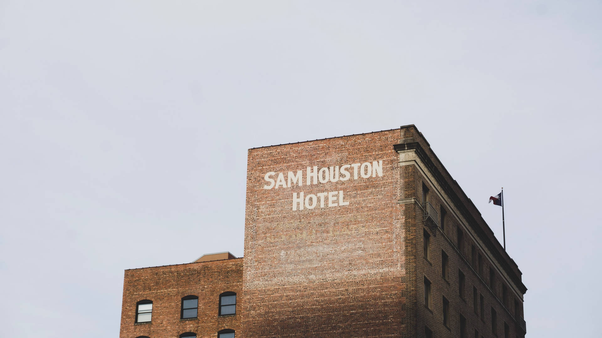 Brick Structure Of Sam Houston Hotel Background