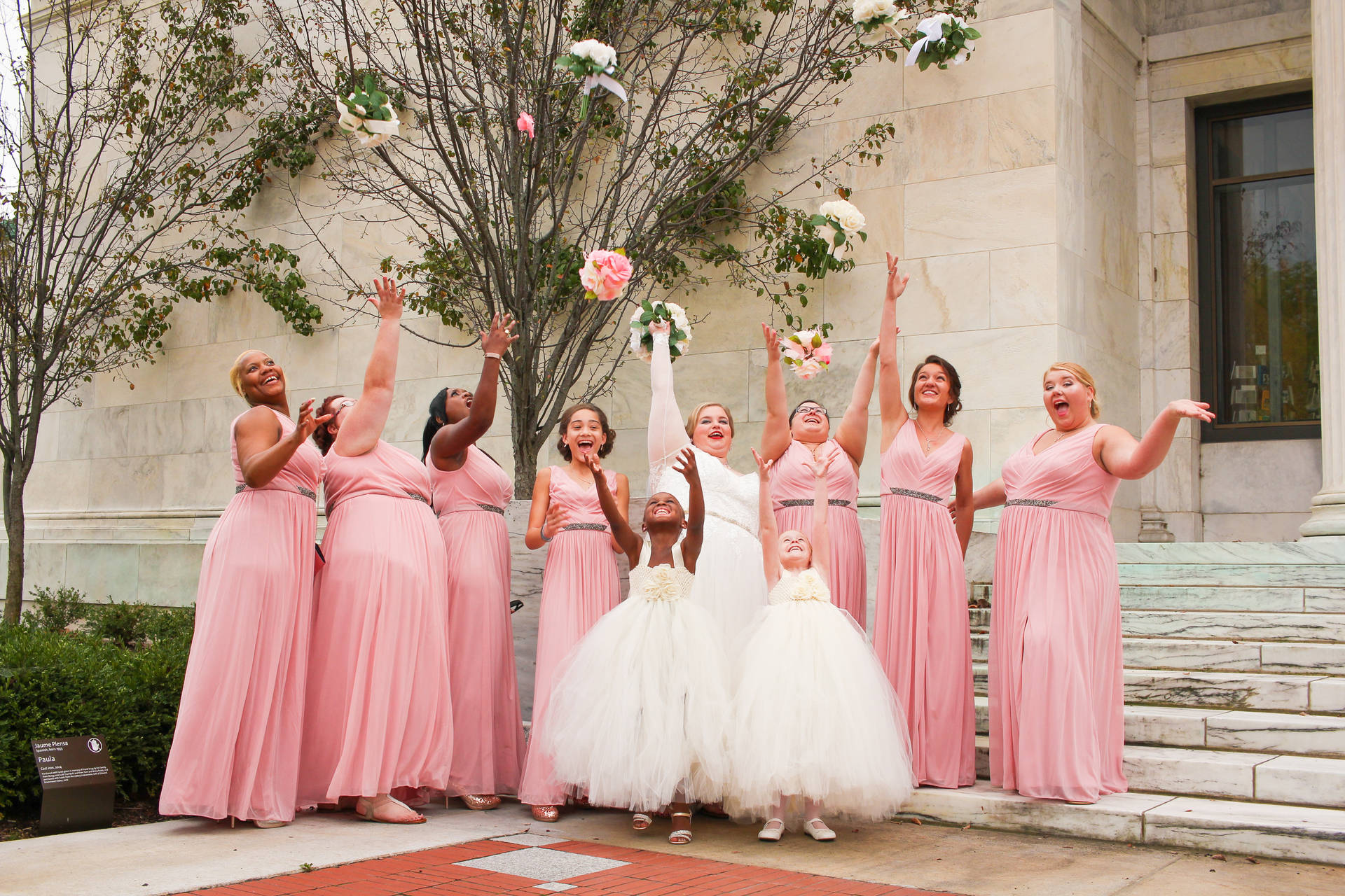 Bridal Party Throwing Their Bouquets Background