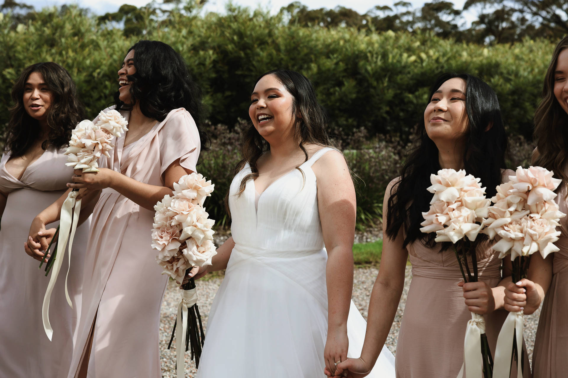 Bride And Bridesmaids Holding Hands