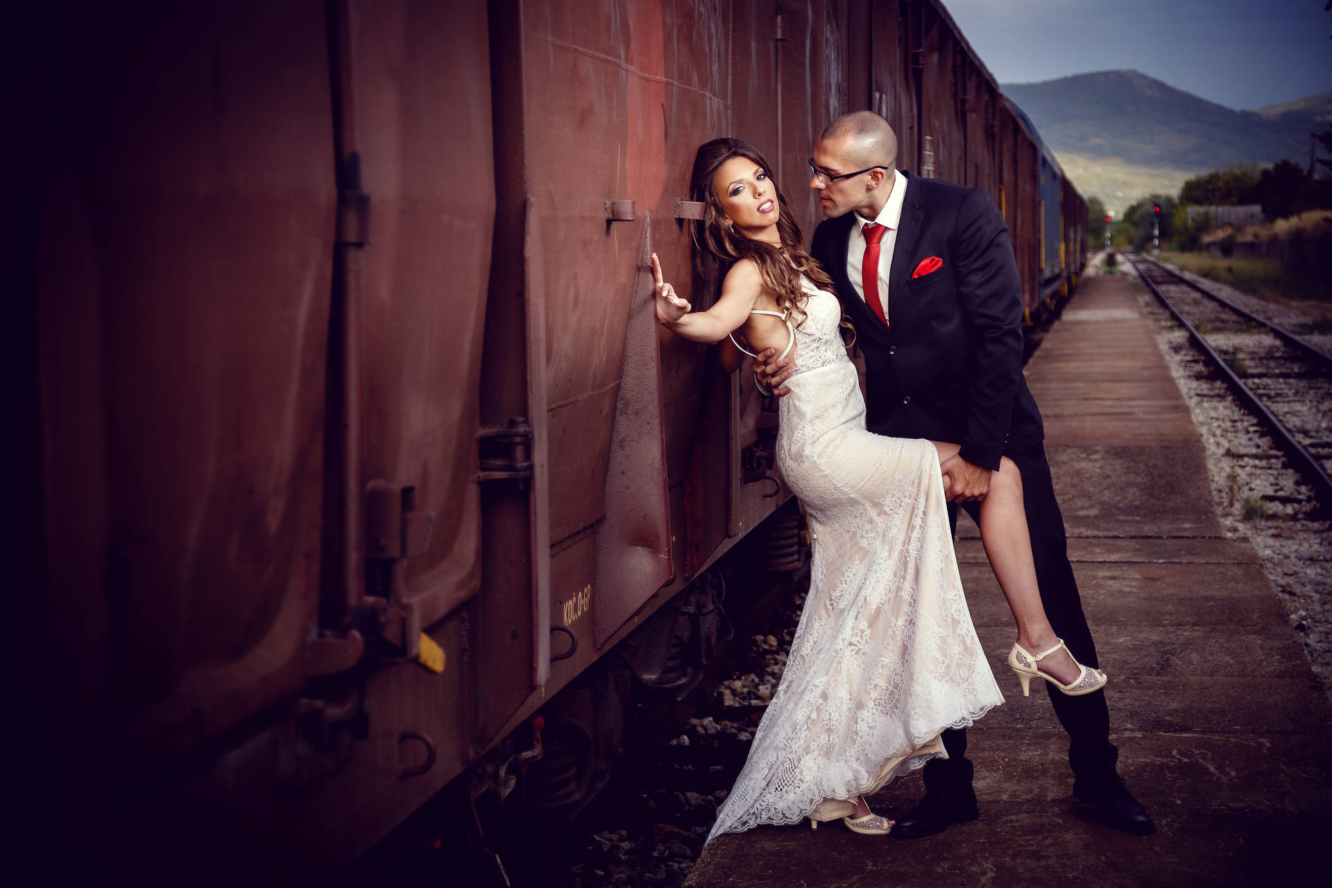Bride And Groom Beside Train Background