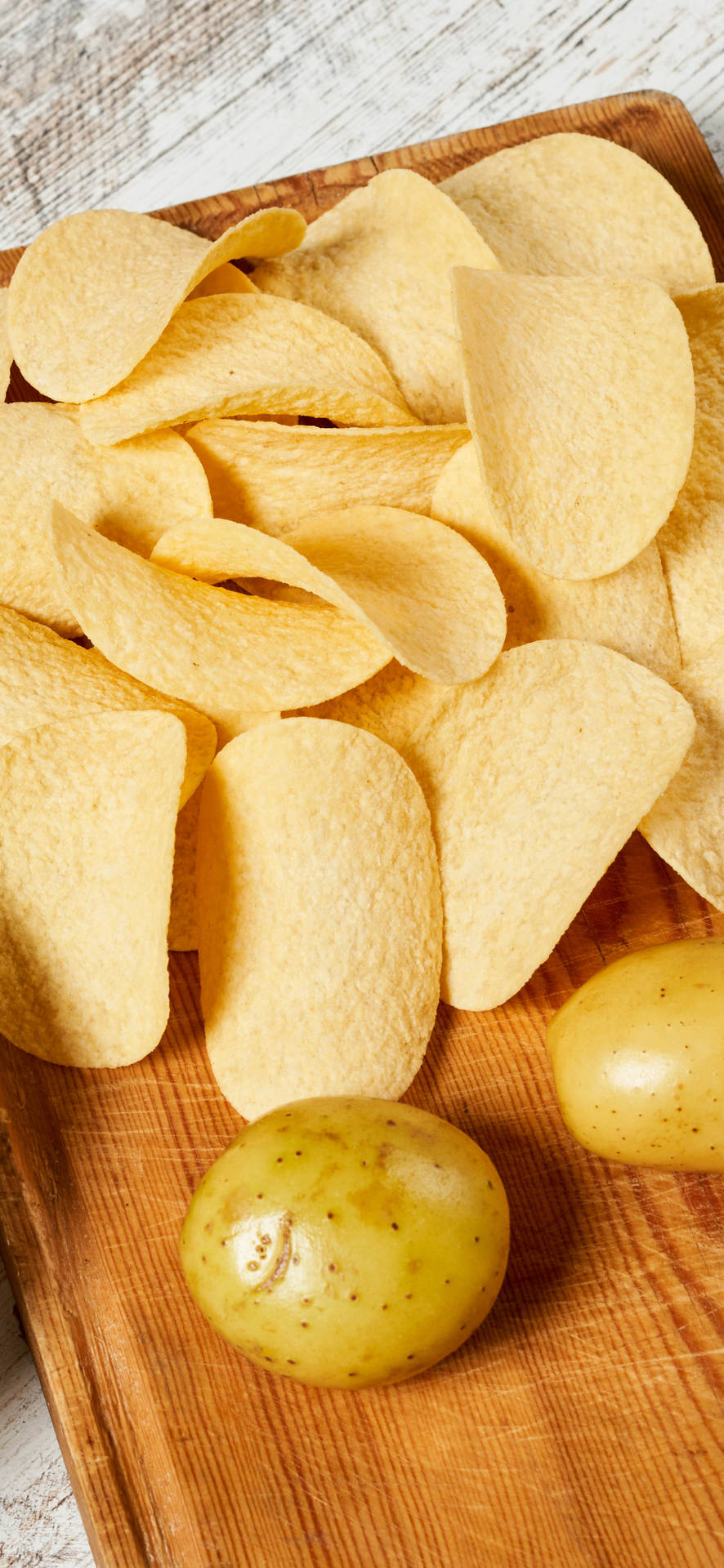 Bright And Crisp Iphone 13 Pro Paired With Delicious Potato Chips Background
