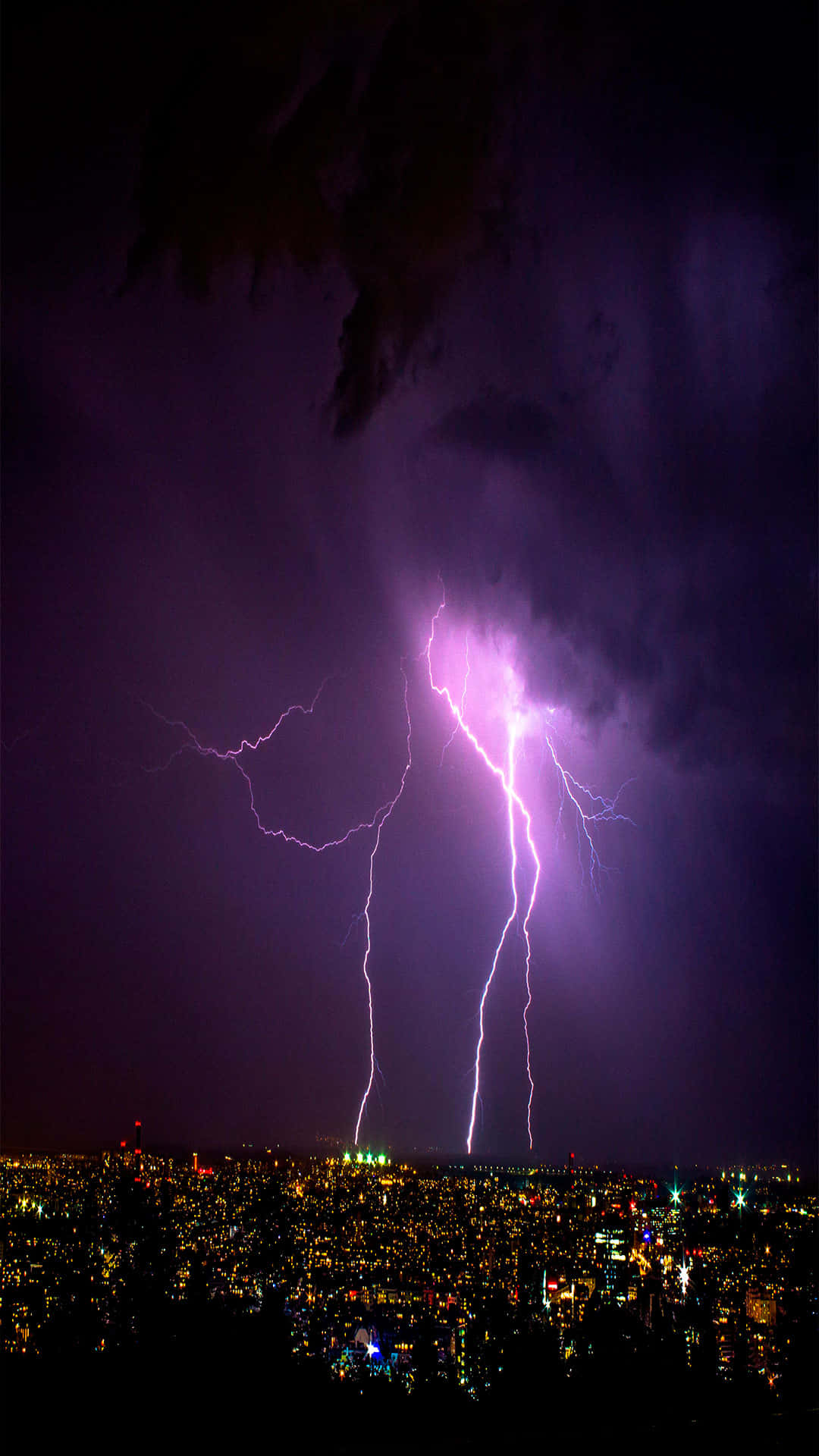 Bright Purple Lightning Illuminating The Sky Background