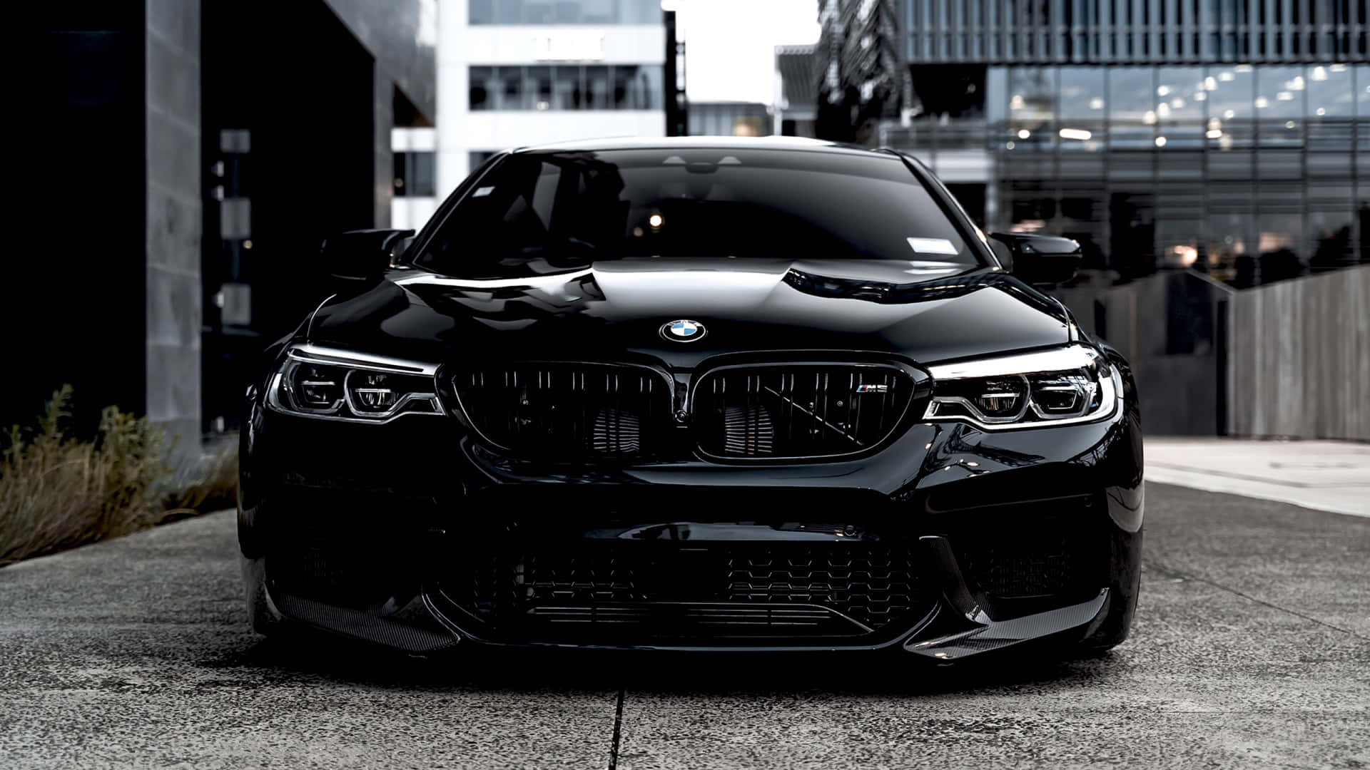 Bright Red Bmw Sedan Parked On The Side Of The Road Background