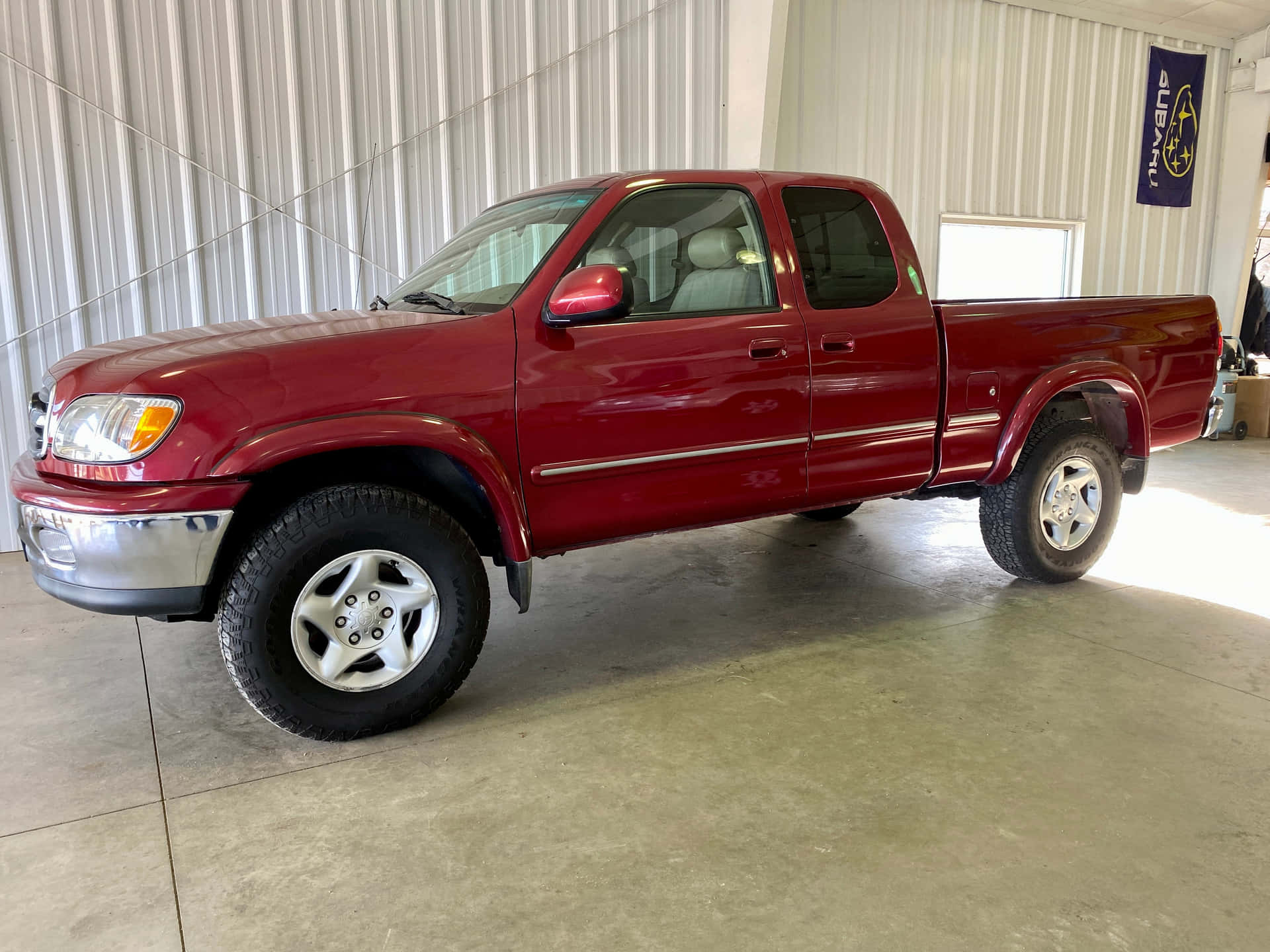 Bright Red Tundra In A Modern Garage Background