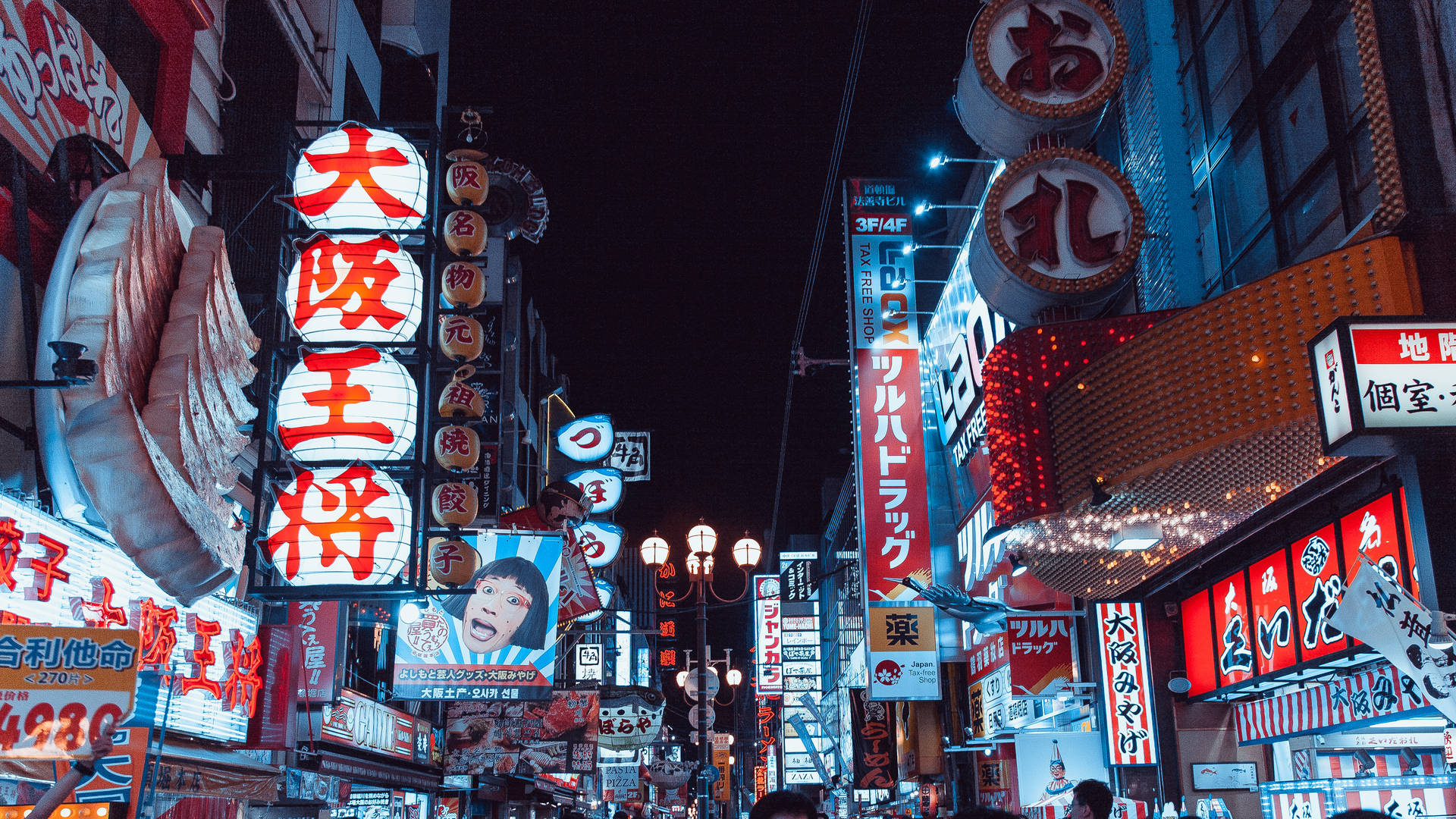 Bright Shop Signs Light Up The Nighttime Street In Tokyo, Japan Background