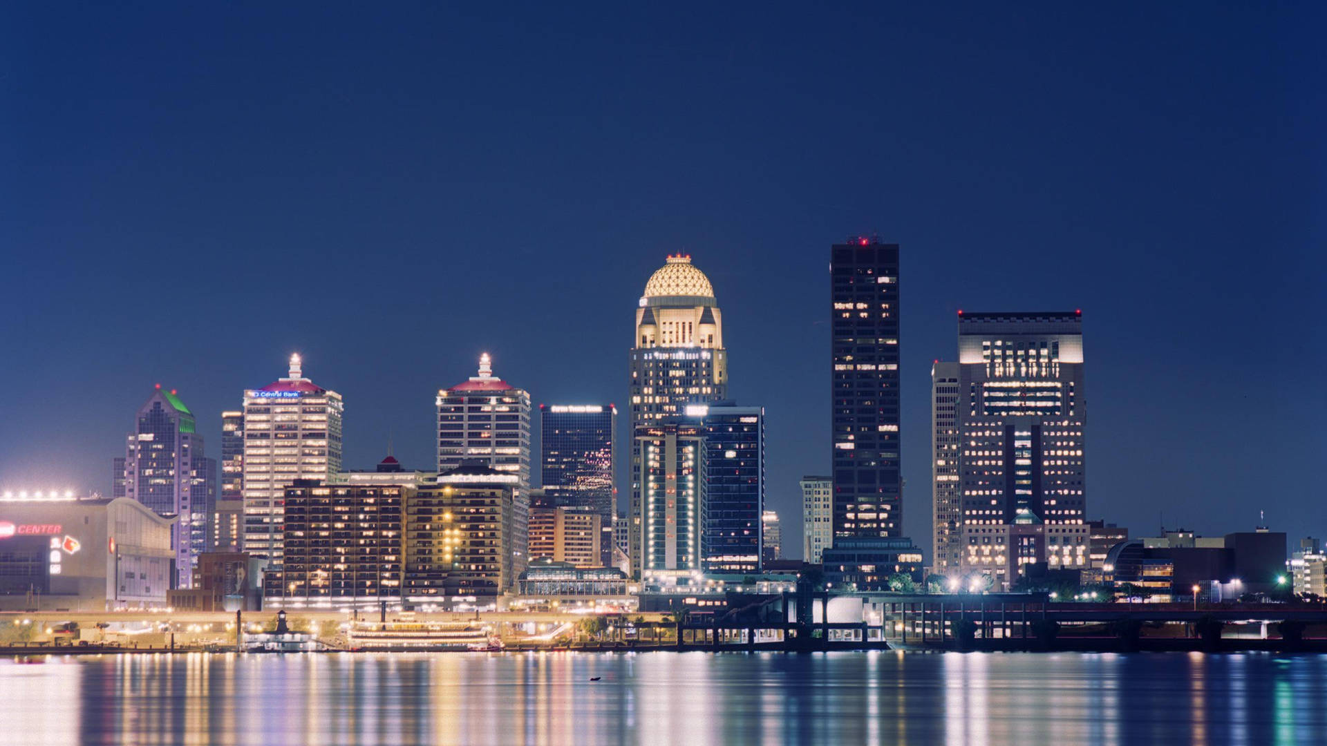 Bright Skyline Louisville At Night Background