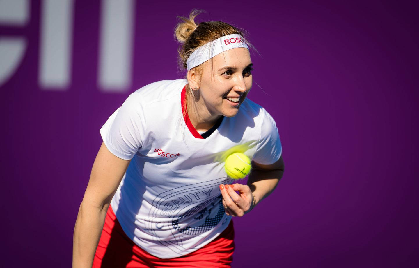 Bright Smiling Elena Vesnina Holding A Tennis Ball