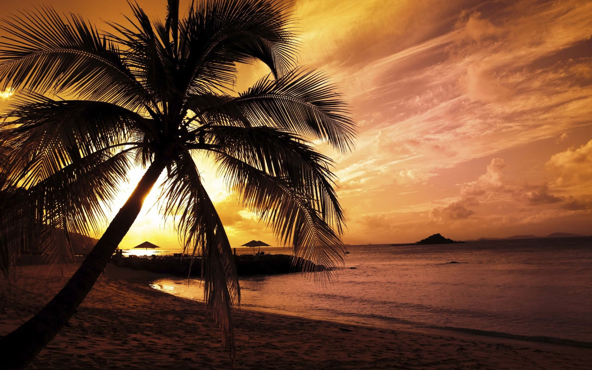 Bright Yellow Sunset Glistening Off The Calm Seas In A Tropical Paradise Background