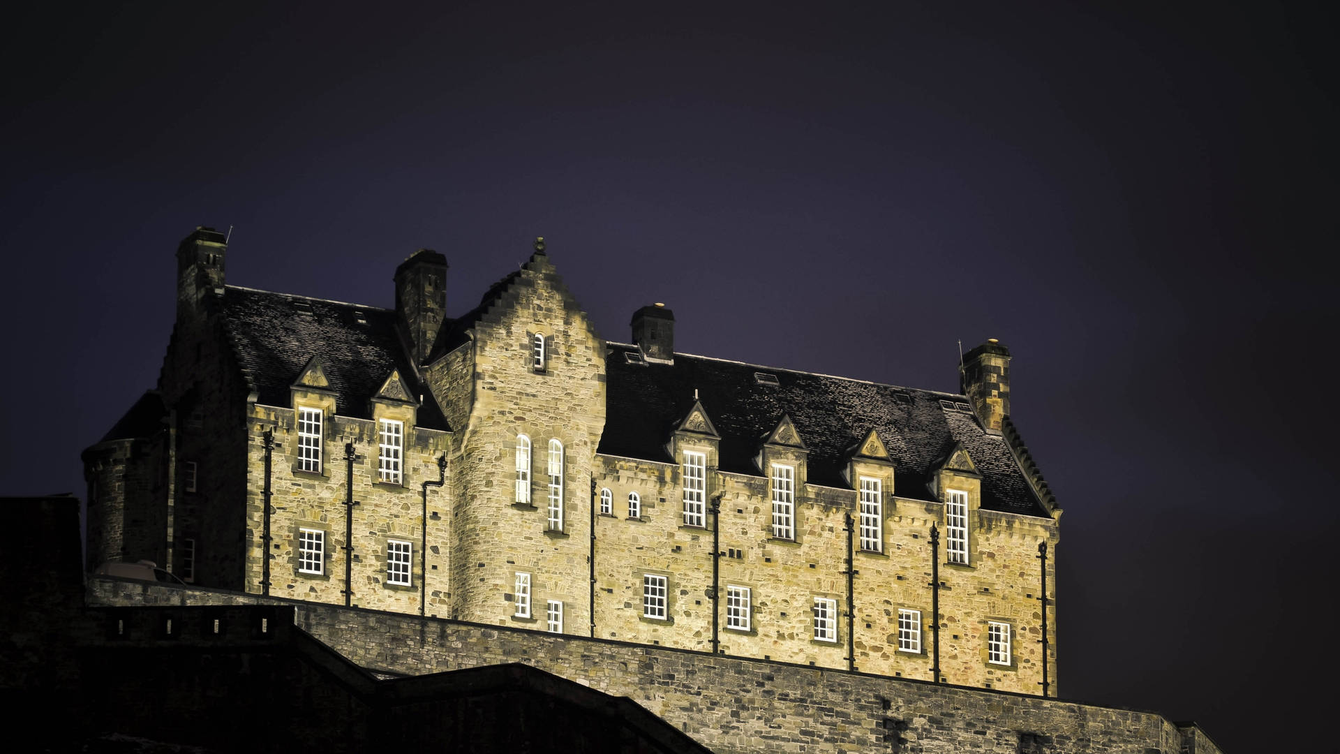 Brightened Edinburgh Castle At Night Background