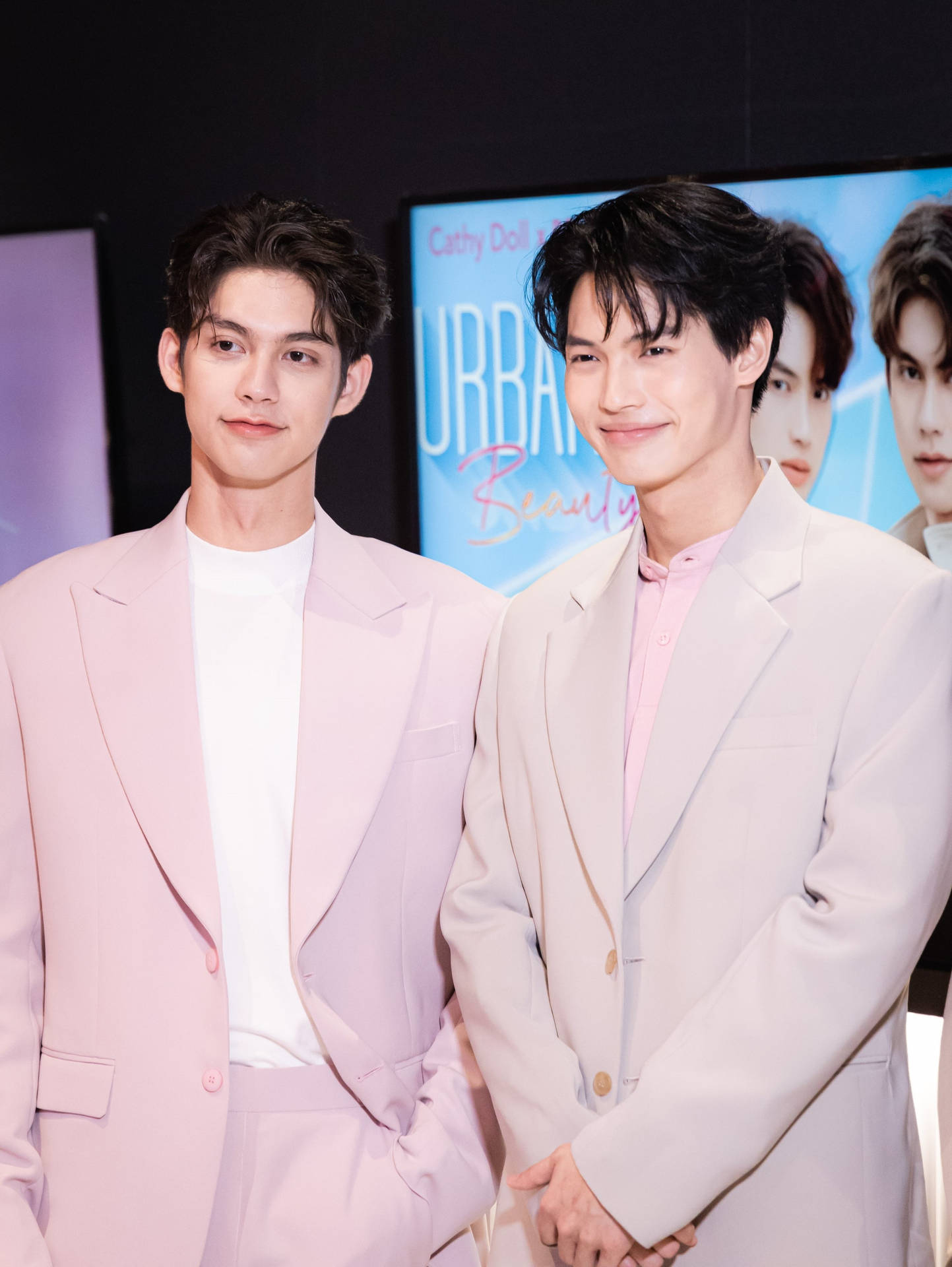 Brightwin Duo Dazzling In Pink Suits Background