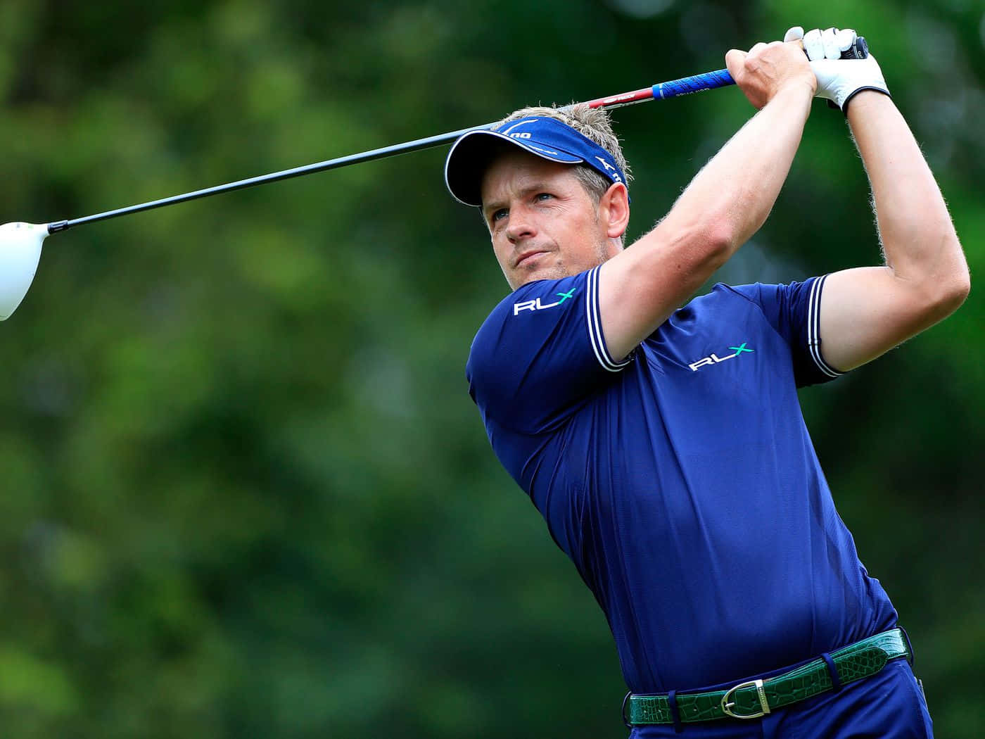 Briny Baird Perfecting His Swing On The Golf Course Background