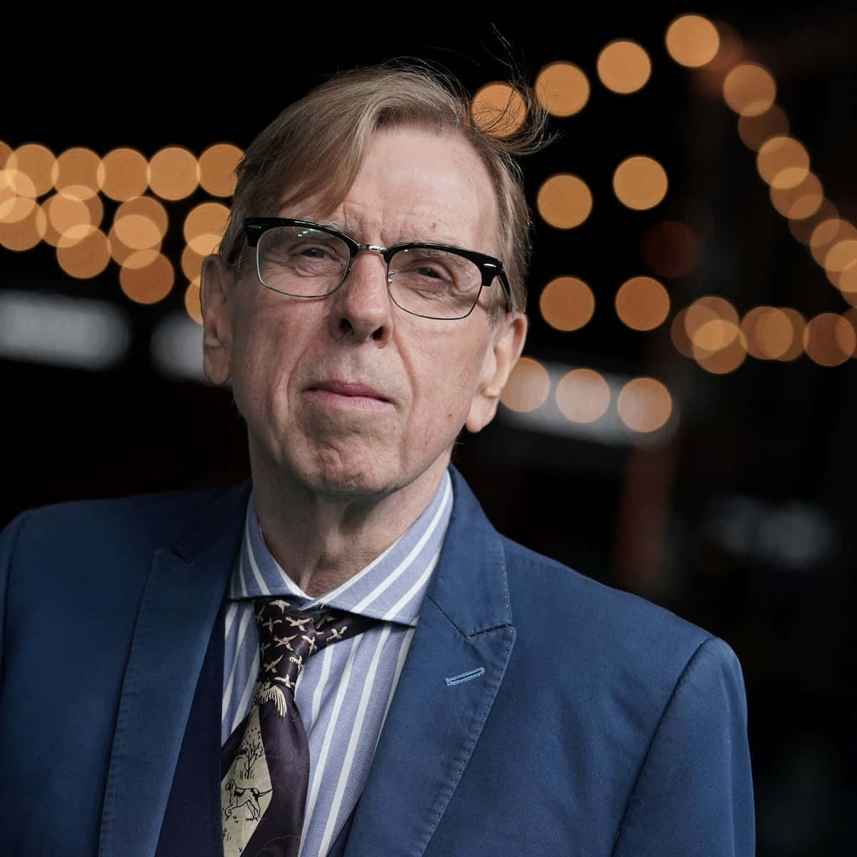 British Actor Timothy Spall Striking A Pose Background