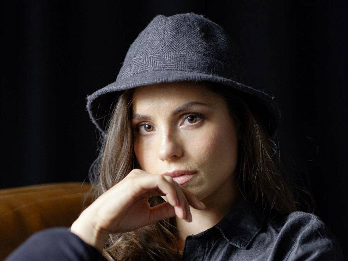 British Actress Charlotte Riley, Donning A Chic Cap Background