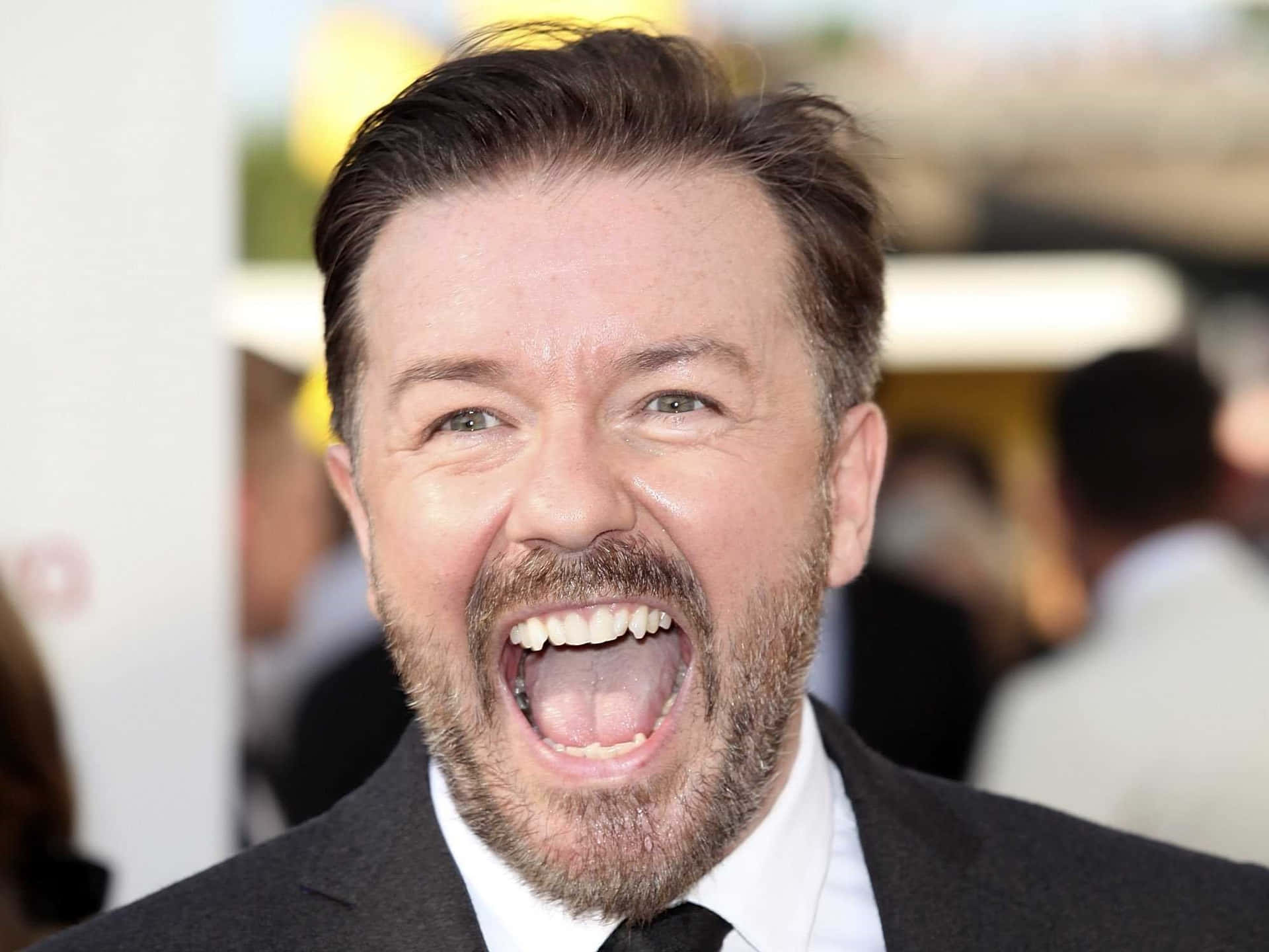 British Comedian And Actor Ricky Gervais Strikes A Pose Background