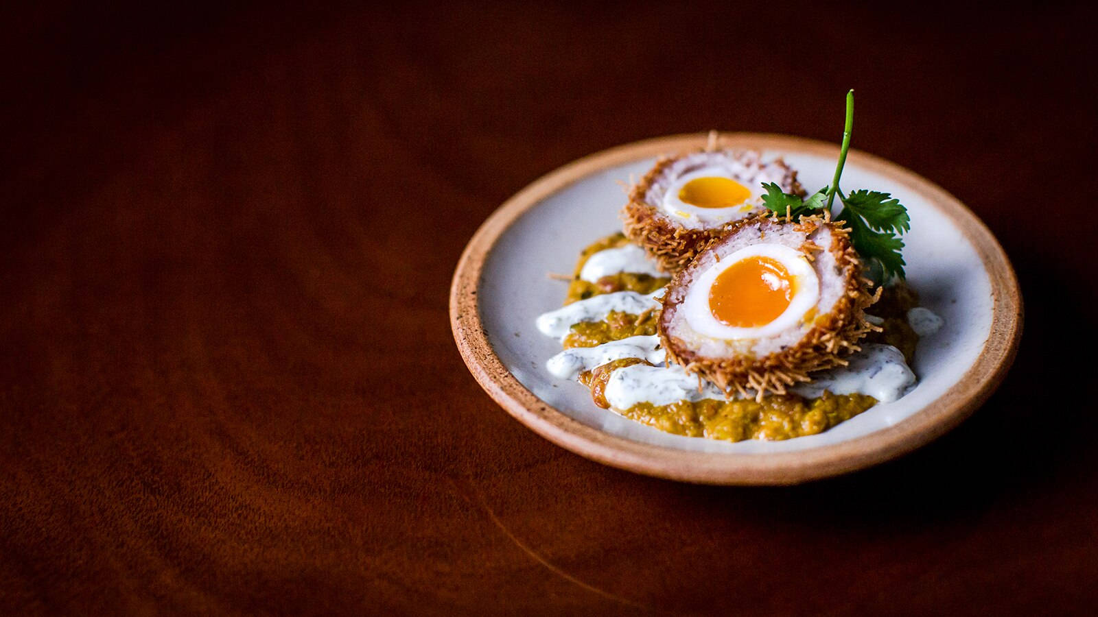 British Scotch Egg Dish With Mustard And Cream Background