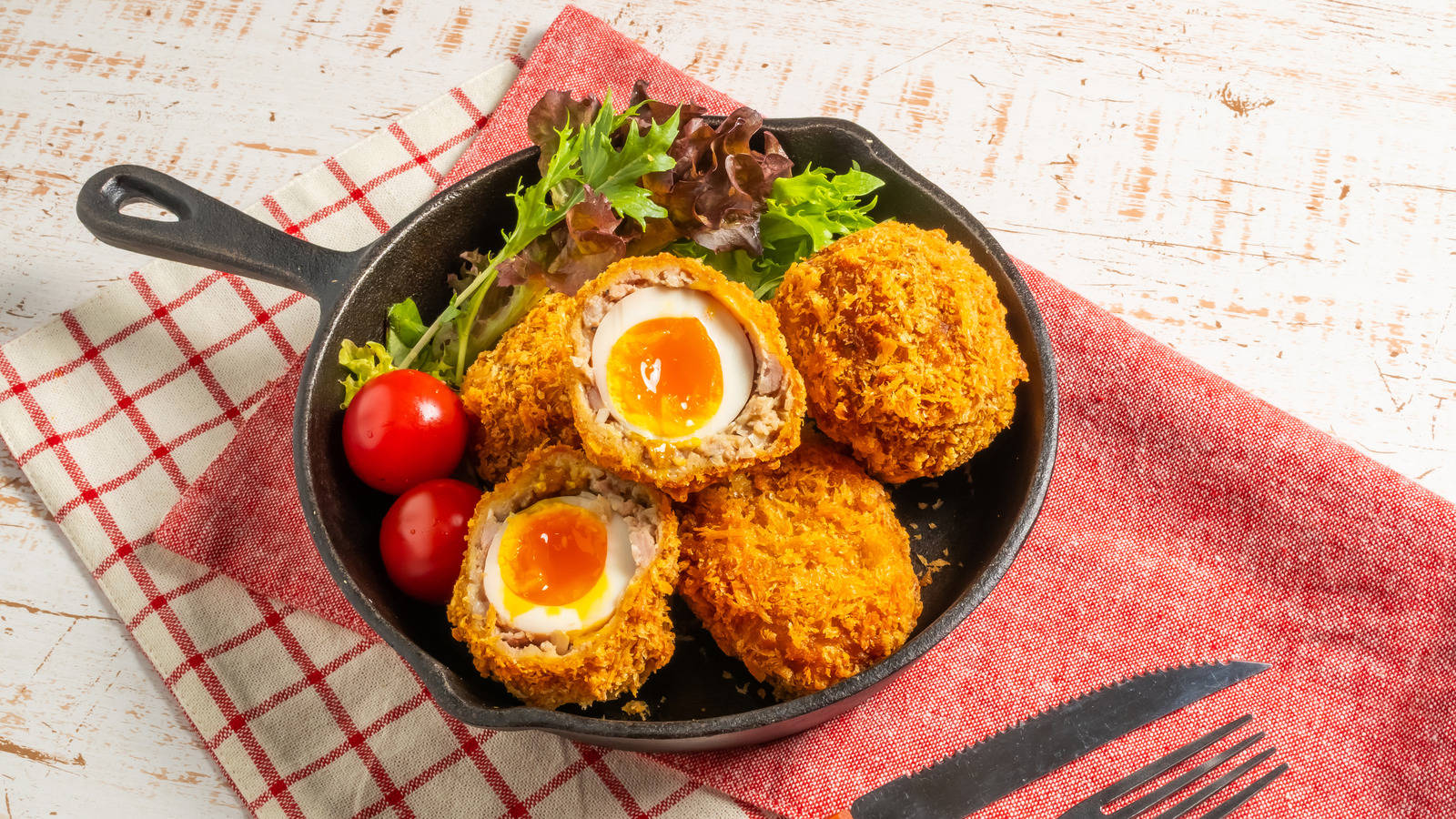 British Scotch Eggs Dish With Tomato And Herbs Background