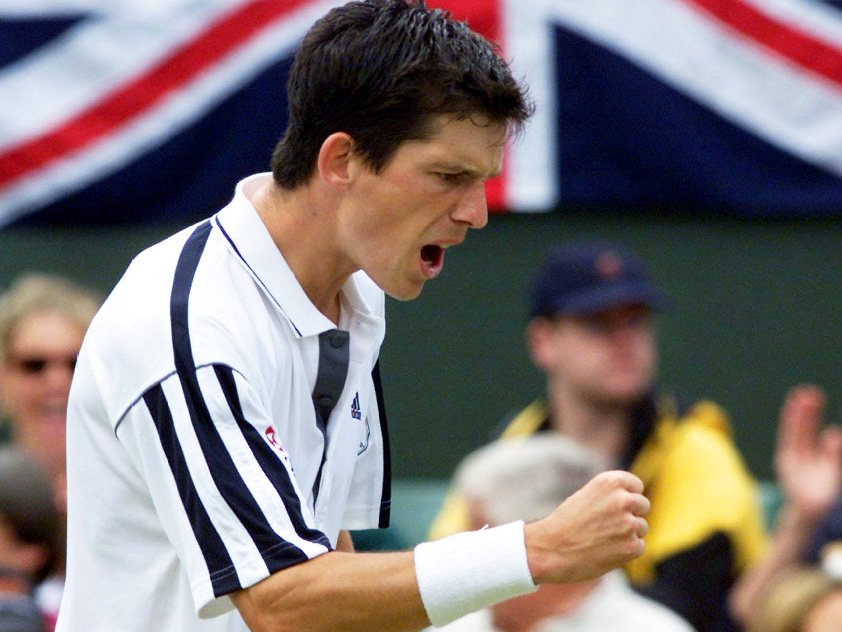 British Tennis Icon Tim Henman Celebrating Victory With Clenched Fist. Background