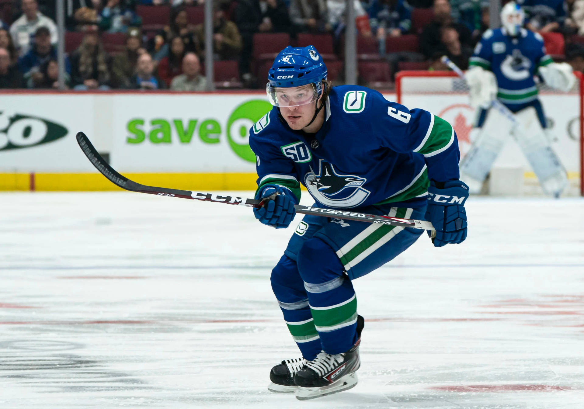 Brock Boeser In Action For Vancouver Canucks Against Minnesota Wild Background