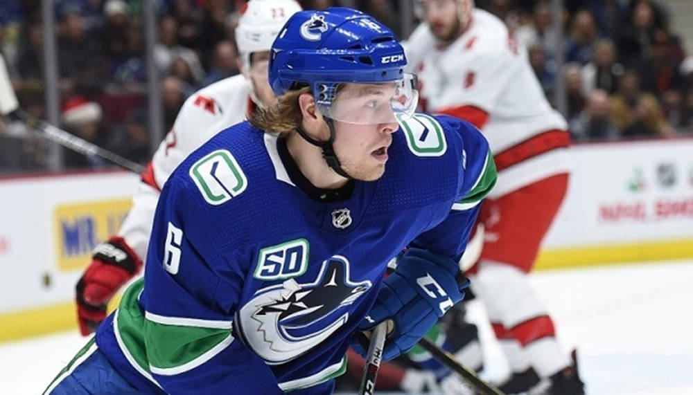 Brock Boeser Vancouver Canucks Chasing Puck Background