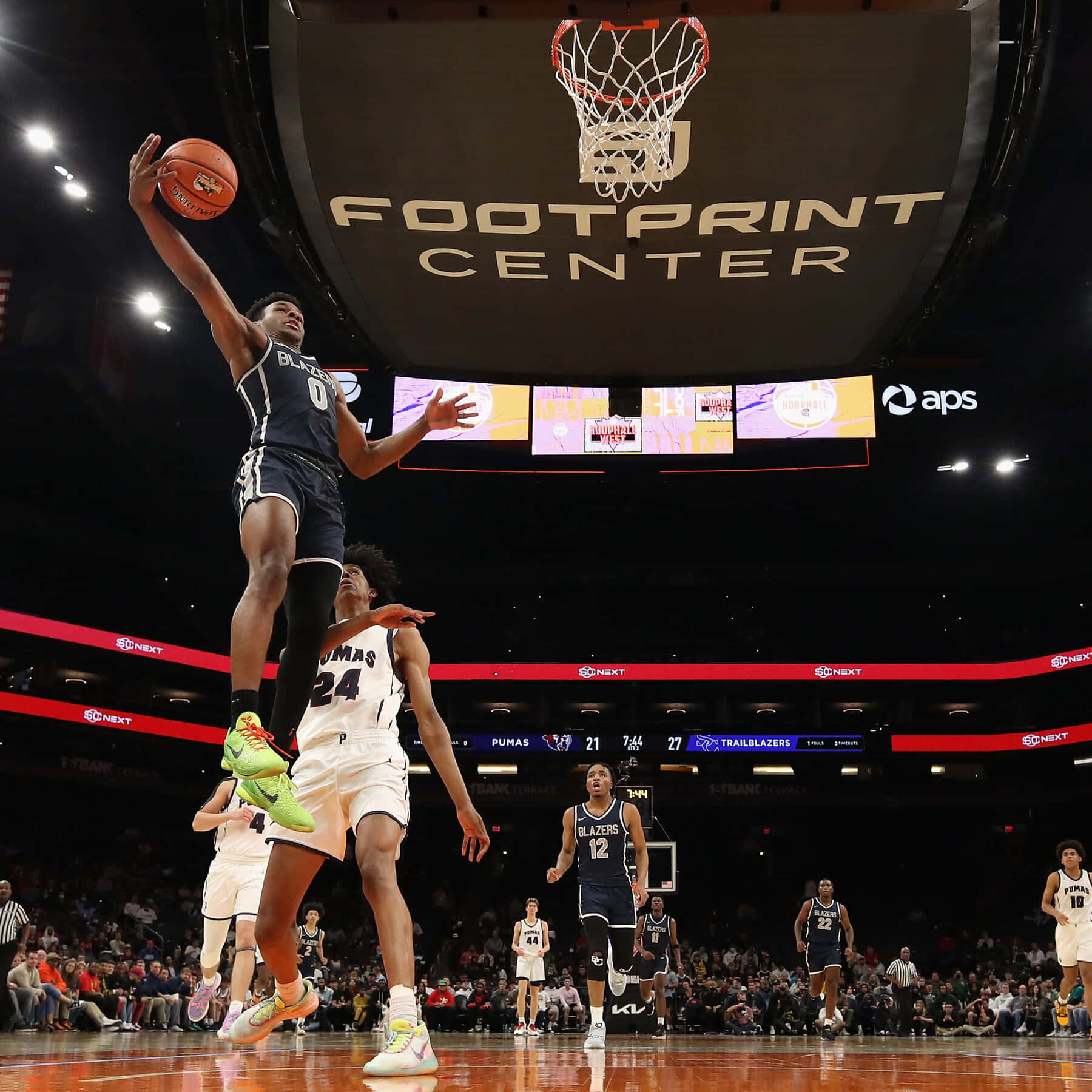 Bronny James Soaring To Victory On The Court Background