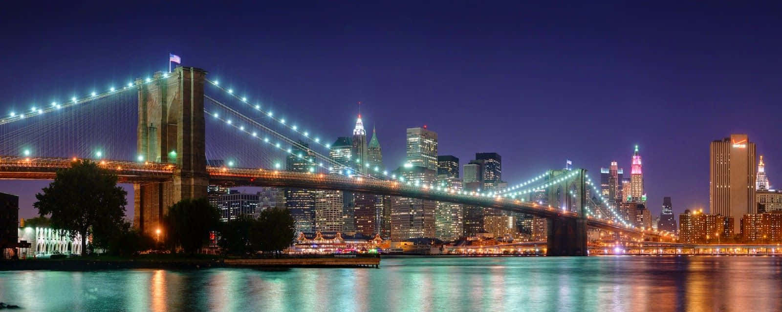 Brooklyn Bridge At Night With The City Lights