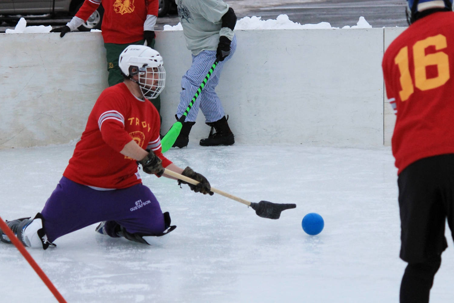 Broomball Player In Action From Red Team. Background