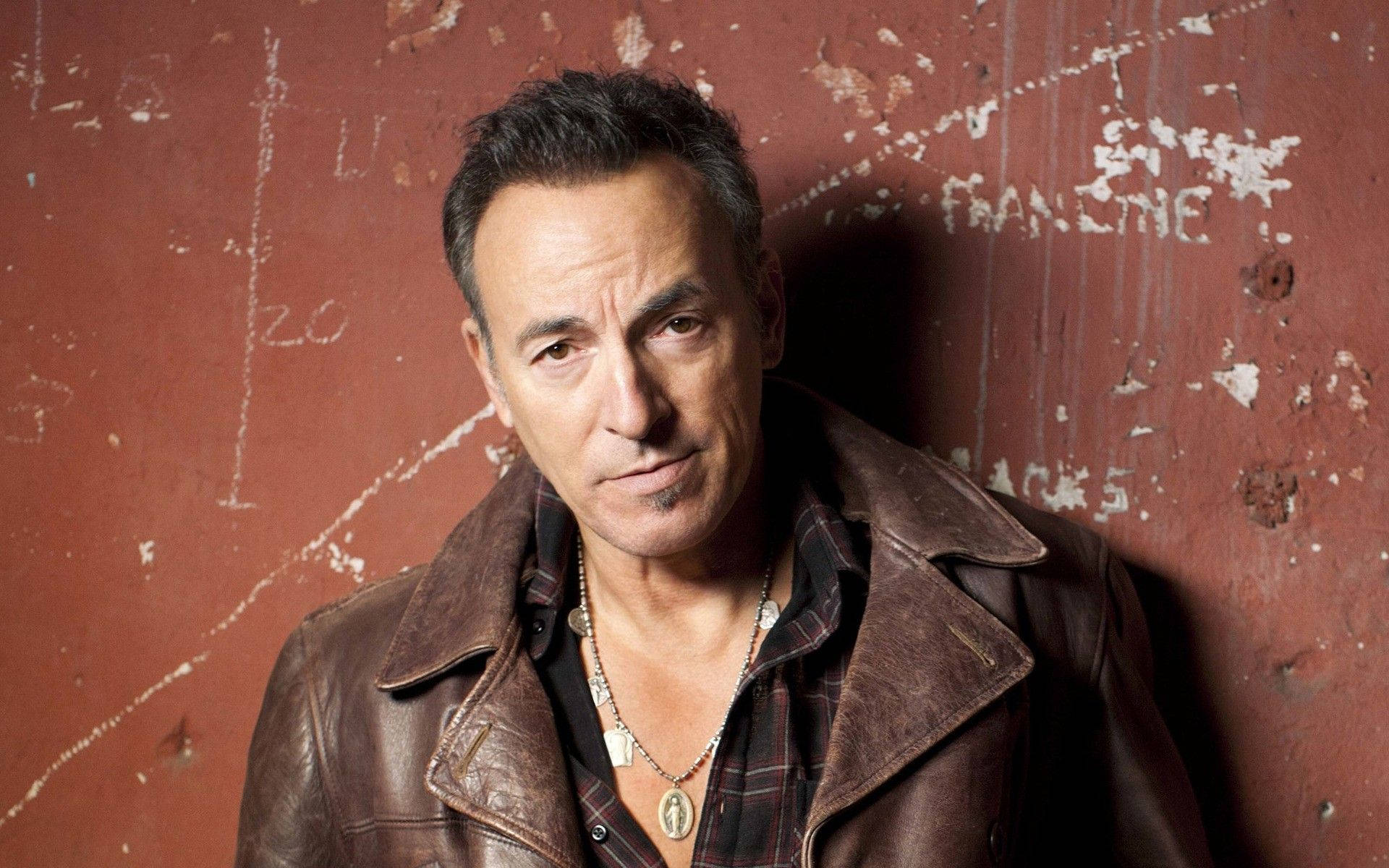 Bruce Springsteen Wearing Miraculous Medal Background