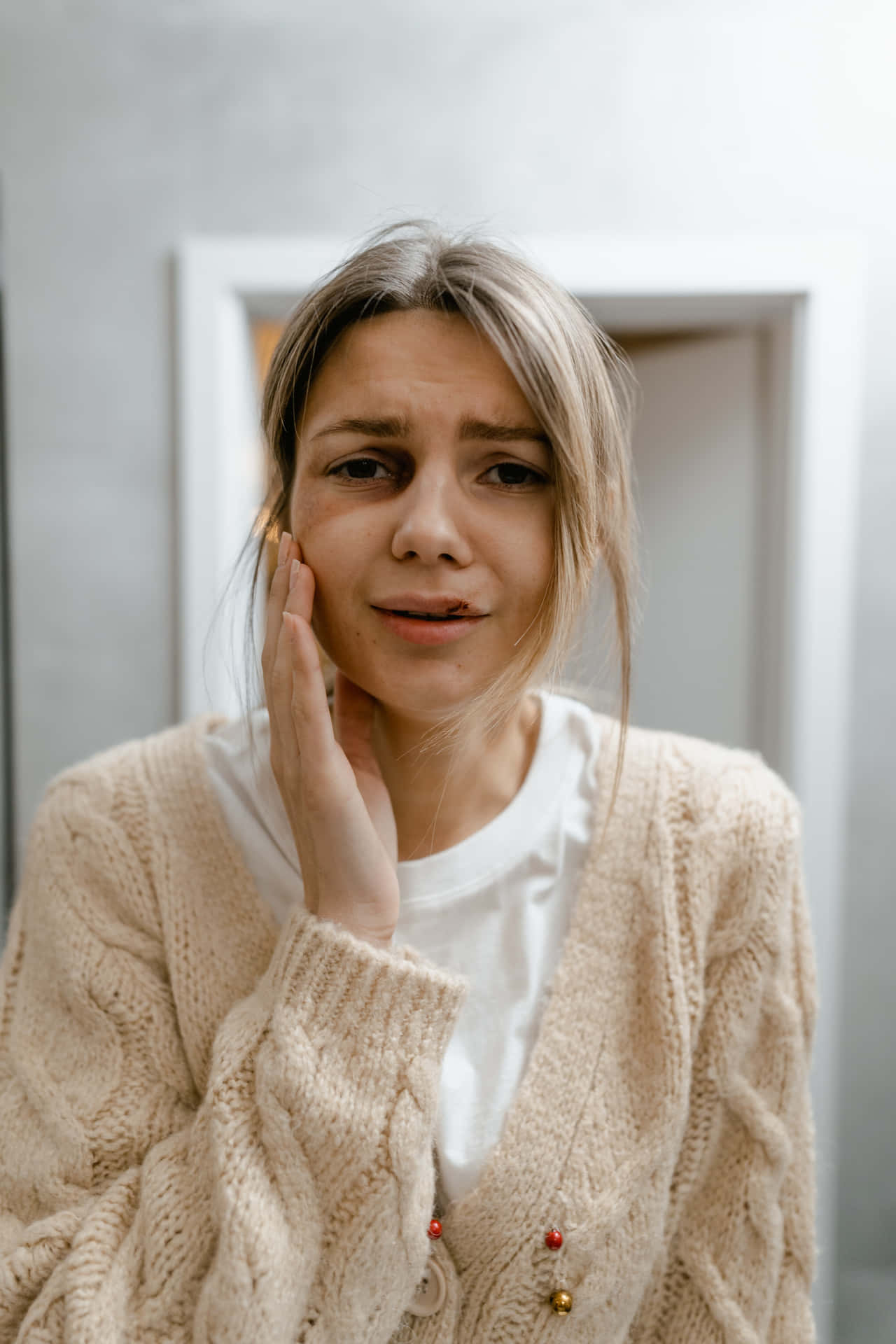 Bruised Girl Holding Cheek Background