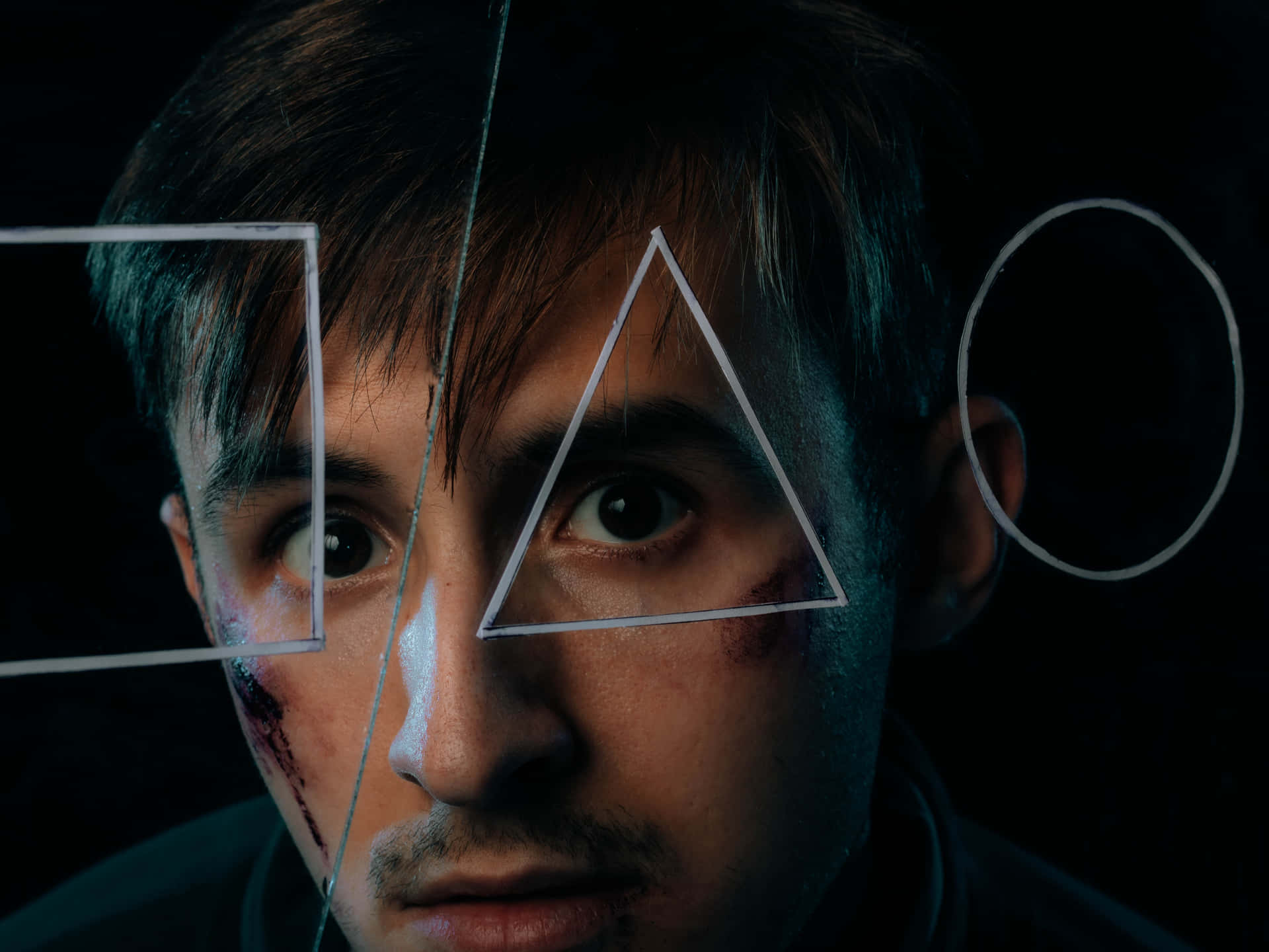 Bruised Man Looking Through Triangle
