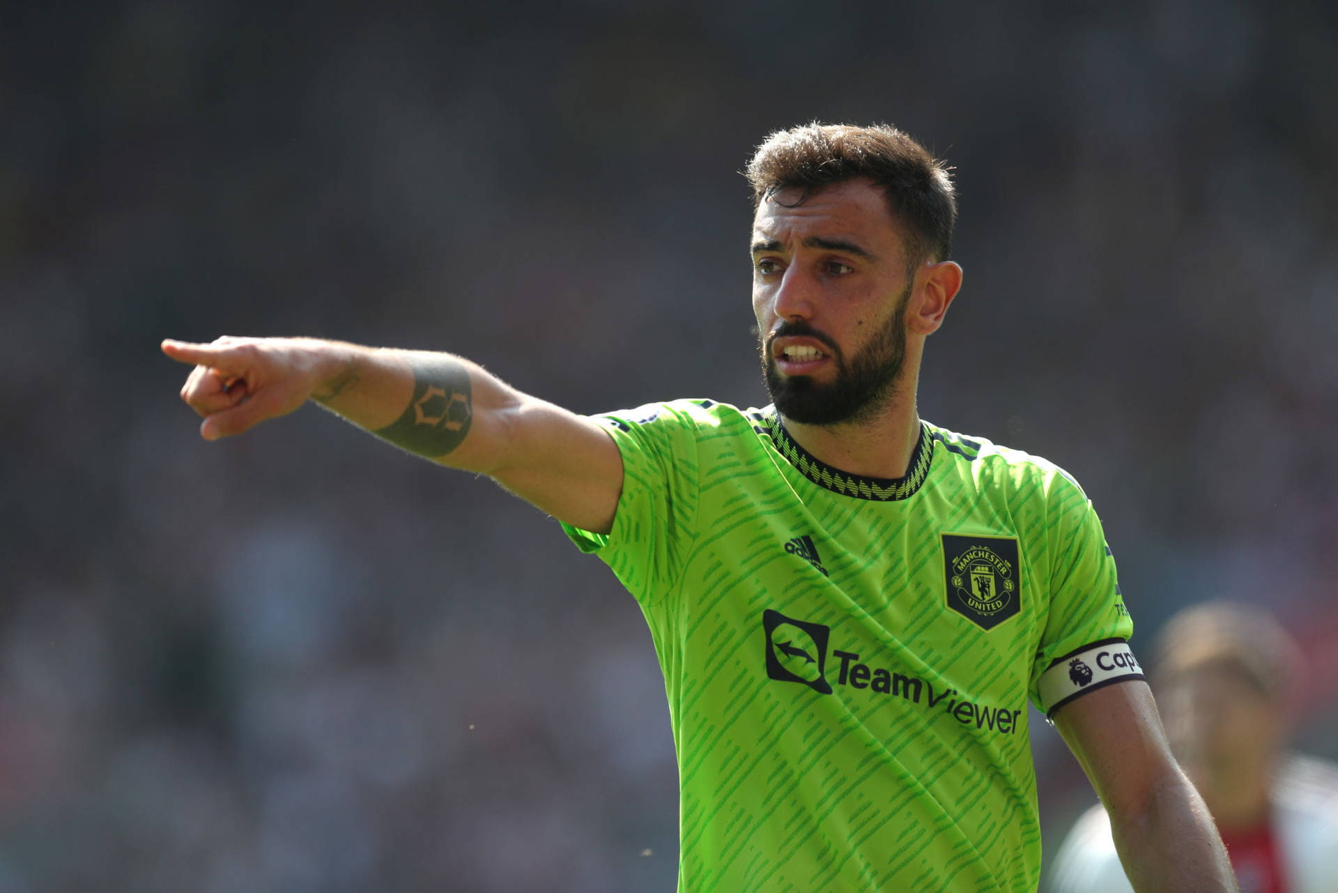 Bruno Fernandes Glowing In Neon Green Jersey Background