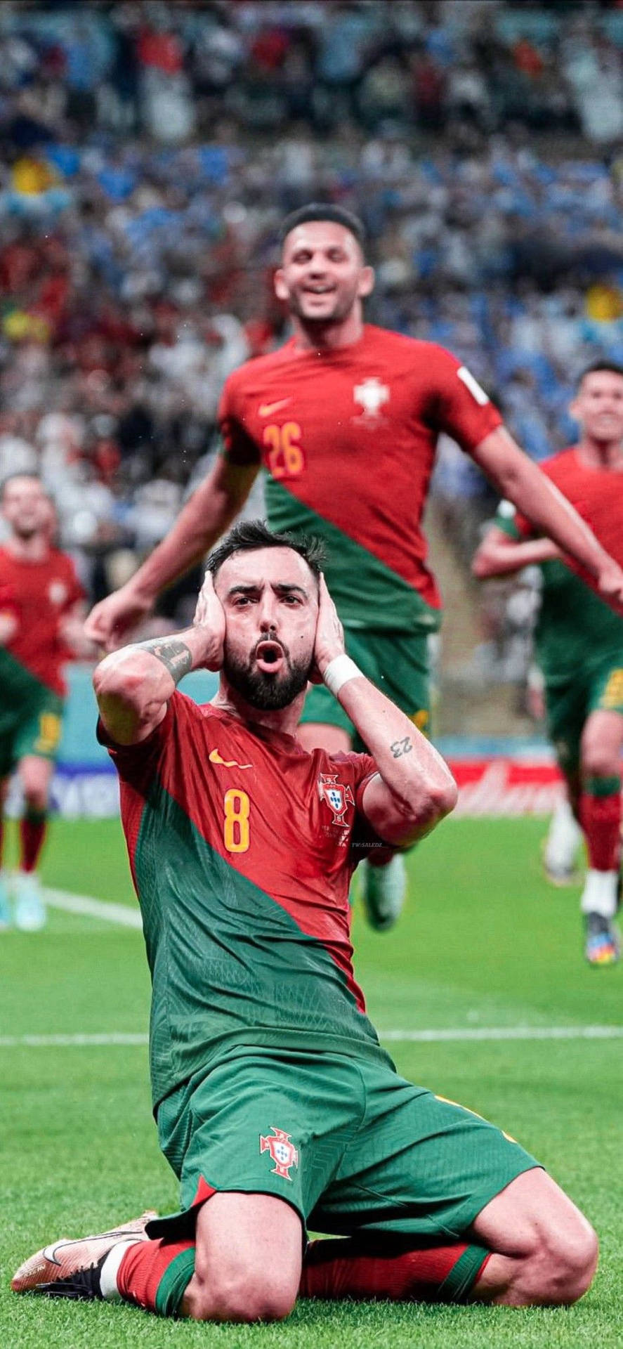 Bruno Fernandes Kneeling Hands In Ears Background