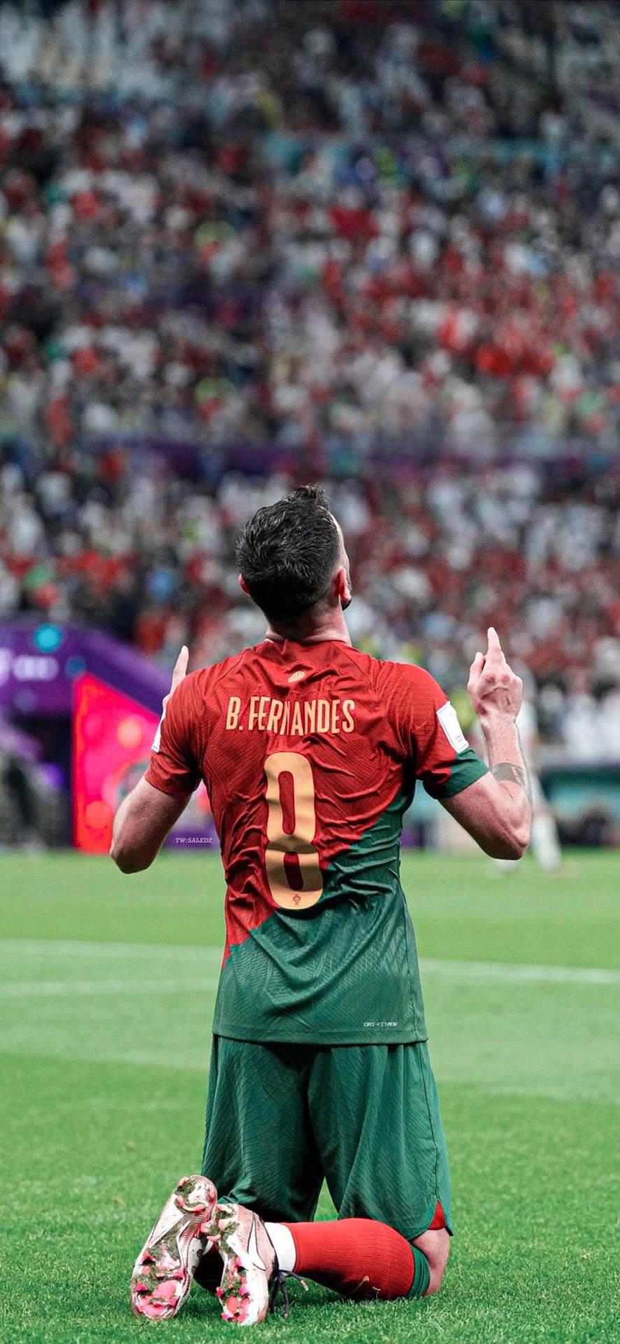 Bruno Fernandes Kneeling Pointing Up Background