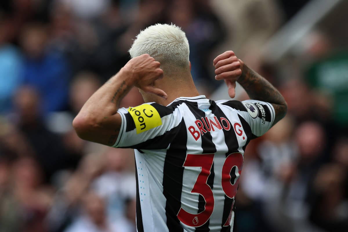 Bruno Guimarães Gesturing To Jersey Background