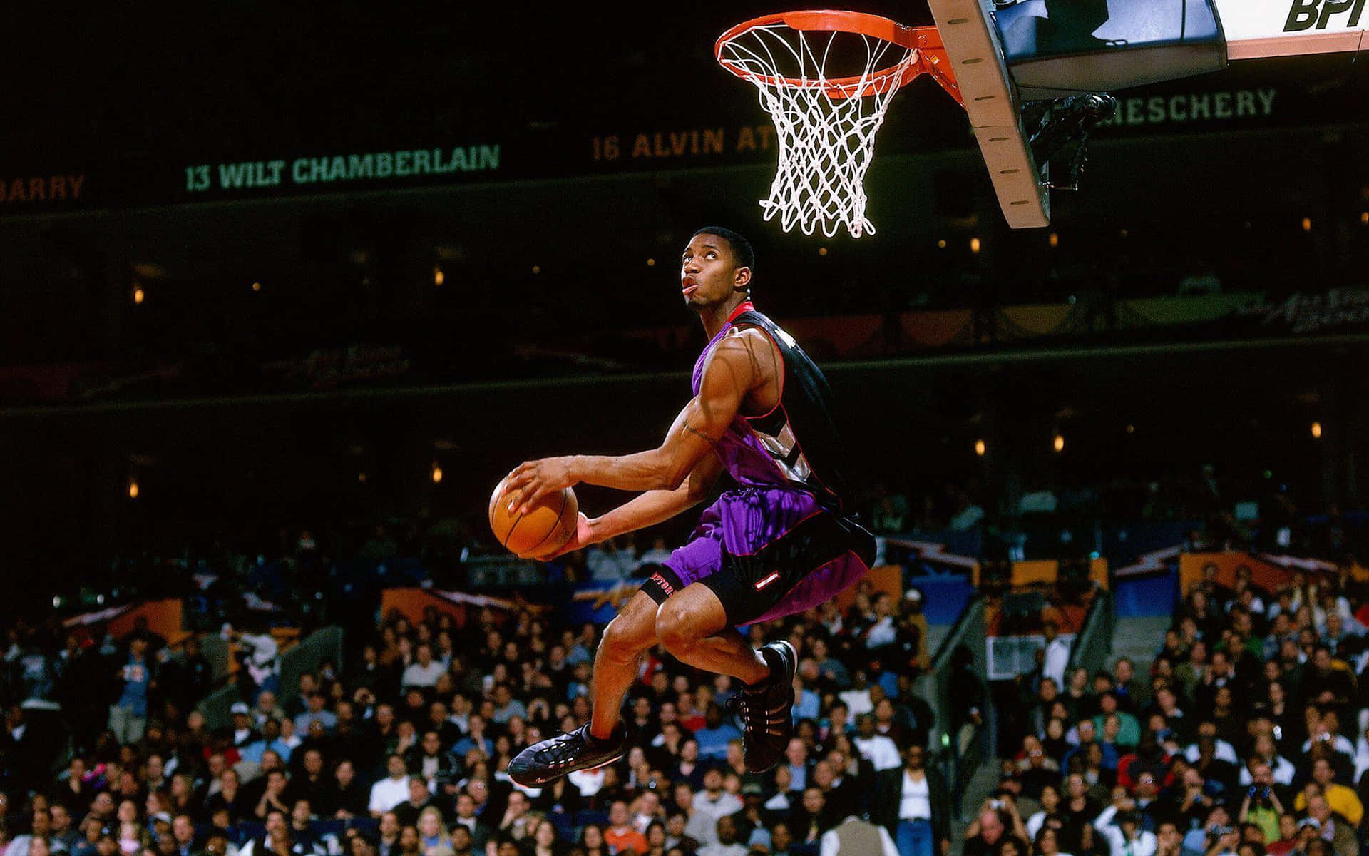 Bryan Mcgrady Flying Through The Air In A Slam Dunk Background