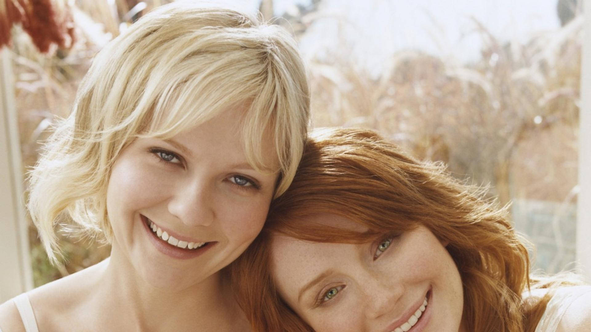 Bryce Dallas Howard Leaning On Kirsten Dunst Background