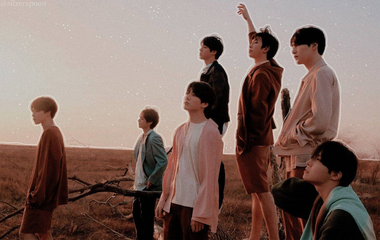 Bts Members On Field At Sunset Laptop