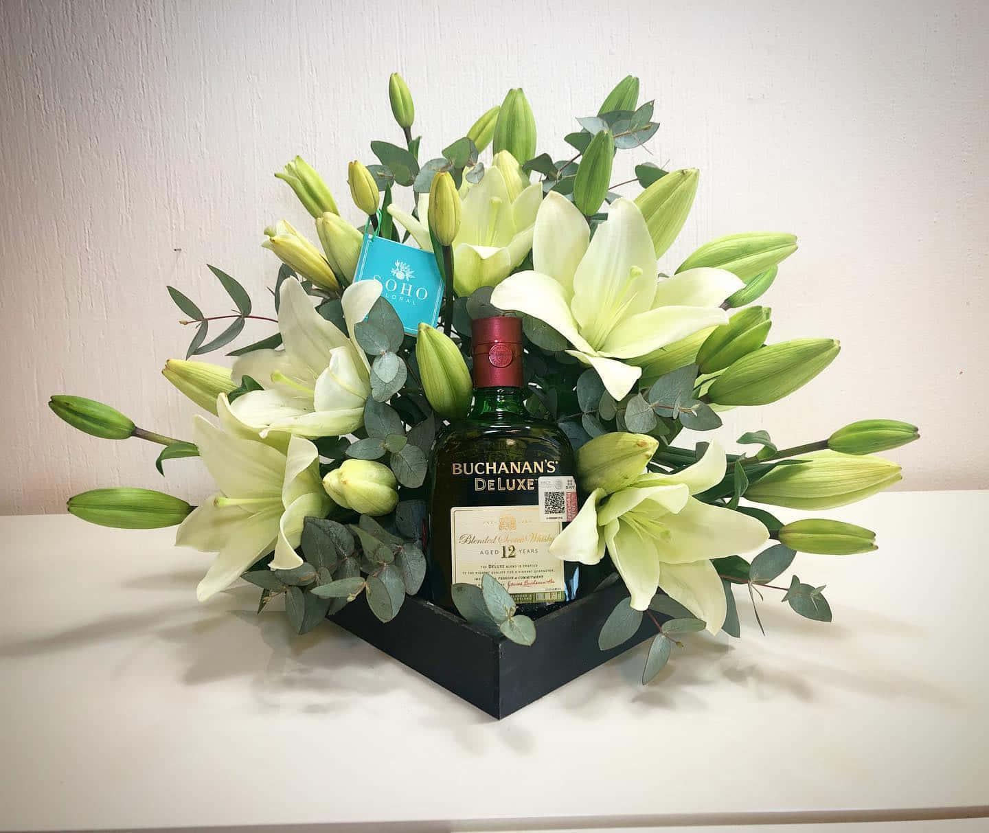 Buchanan's Deluxe Bottle In Flower Arrangement