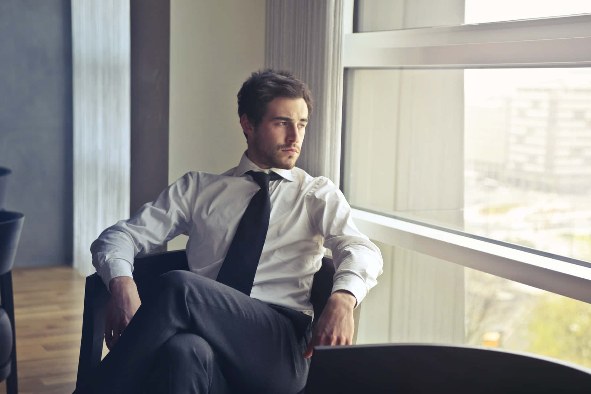Businessman Contemplatingby Window Background