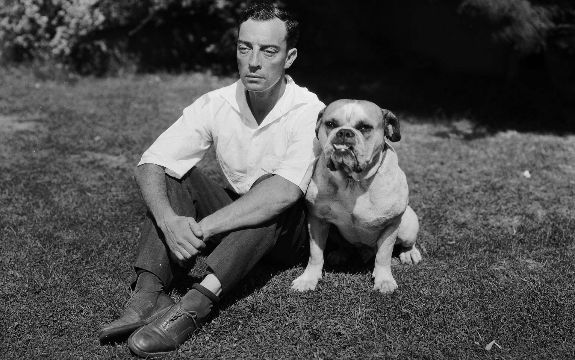 Buster Keaton With His Loyal Sidekick Dog In A Vintage Setting. Background