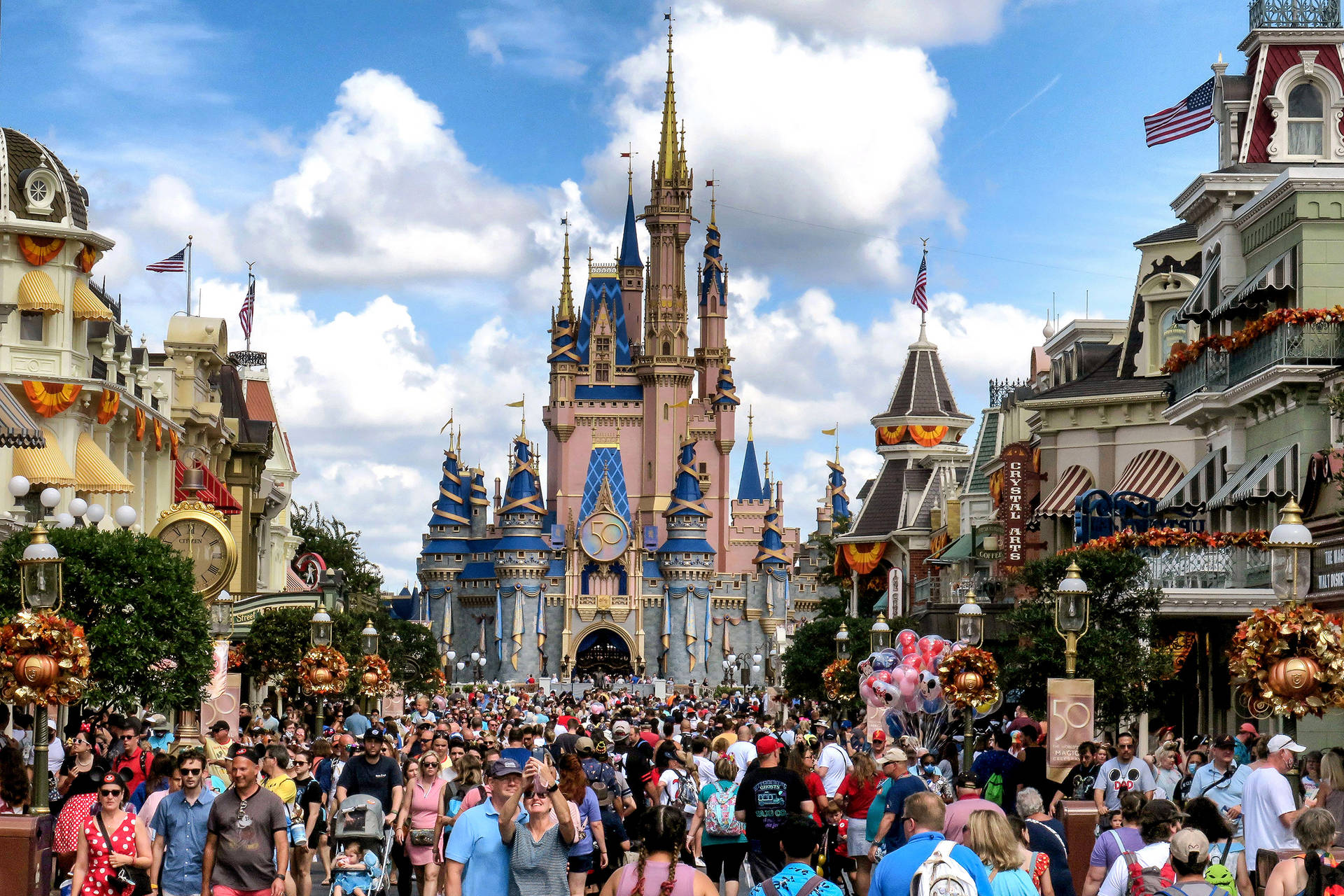 Bustling Disneyworld On A Sunny Day