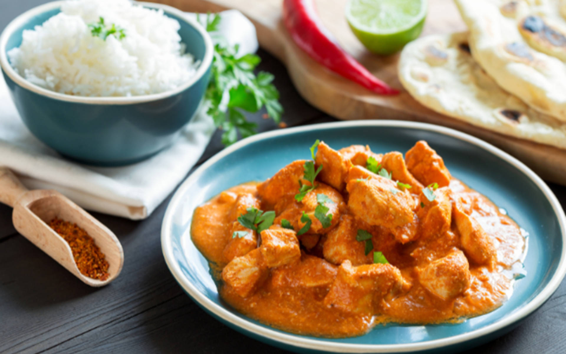 Butter Chicken In Blue Plate Background