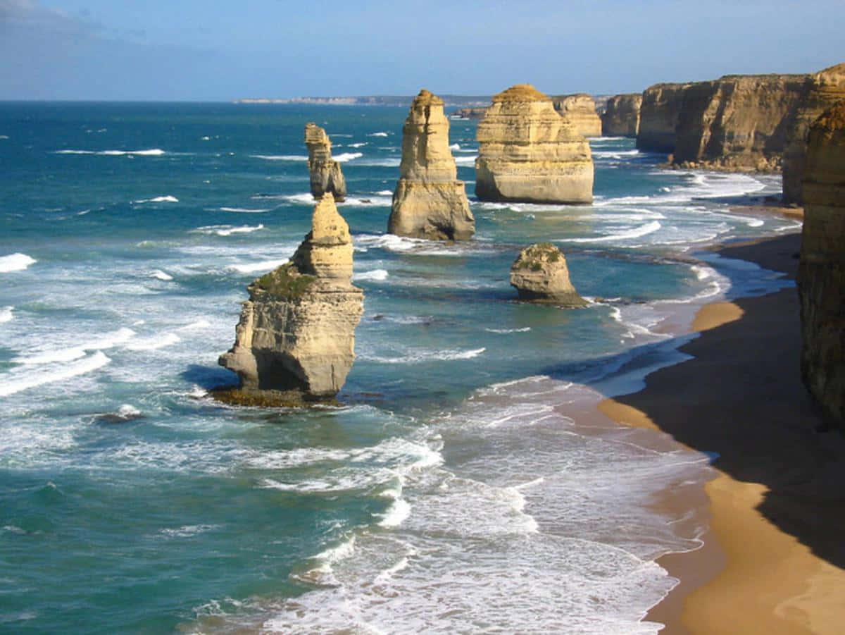 Buzzing Waves In Twelve Apostles In Victoria Australia Background