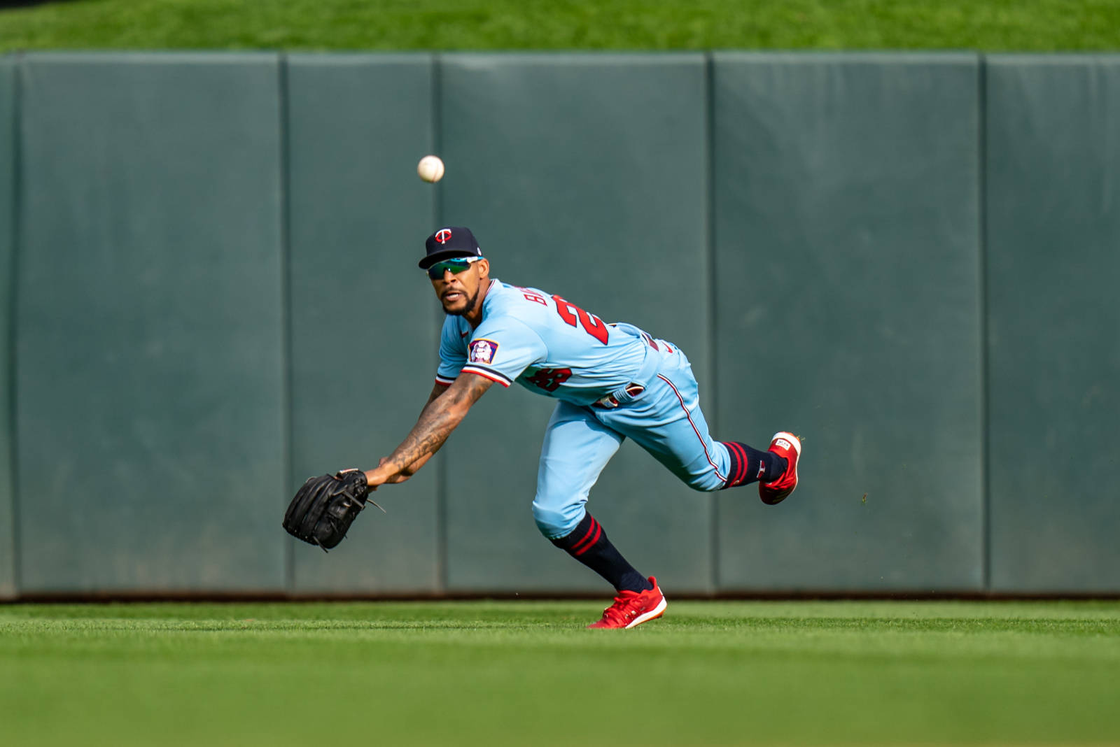 Byron Buxton Catching Baseball On Field Background