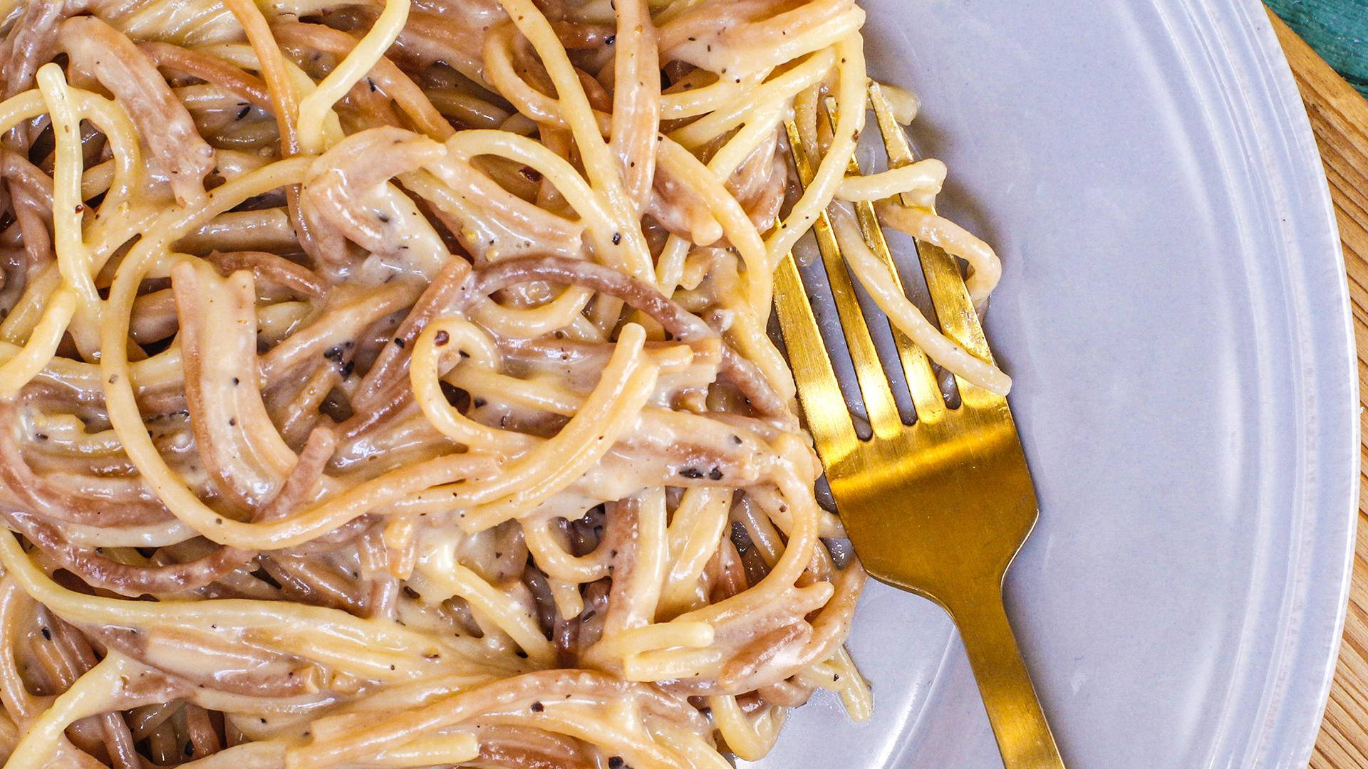 Cacio E Pepe Eaten With A Golden Fork Background