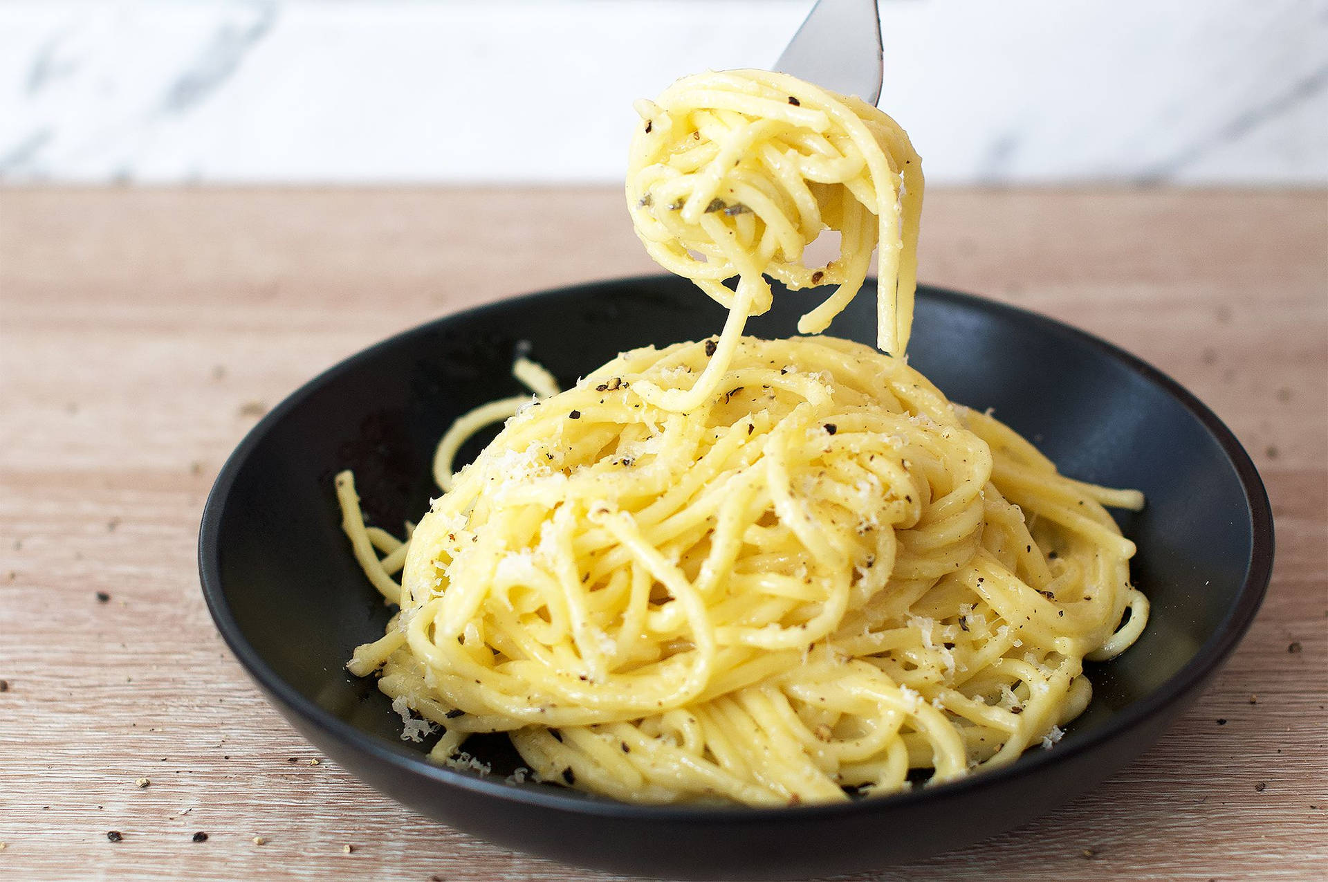 Cacio E Pepe On A Simple Black Plate Background