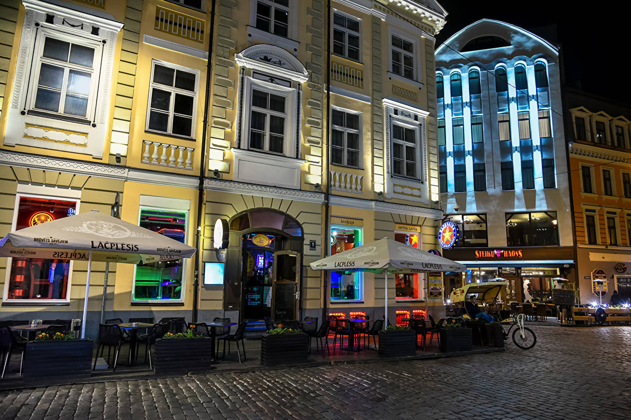 Cafe Street At Night In Riga Background