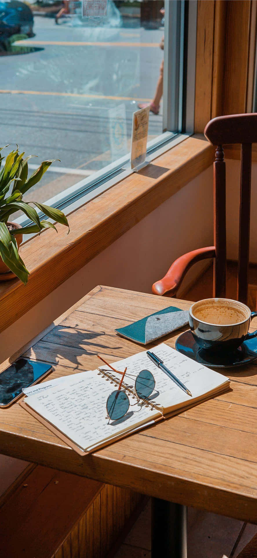 Cafe Table With Coffee And Notebook Background