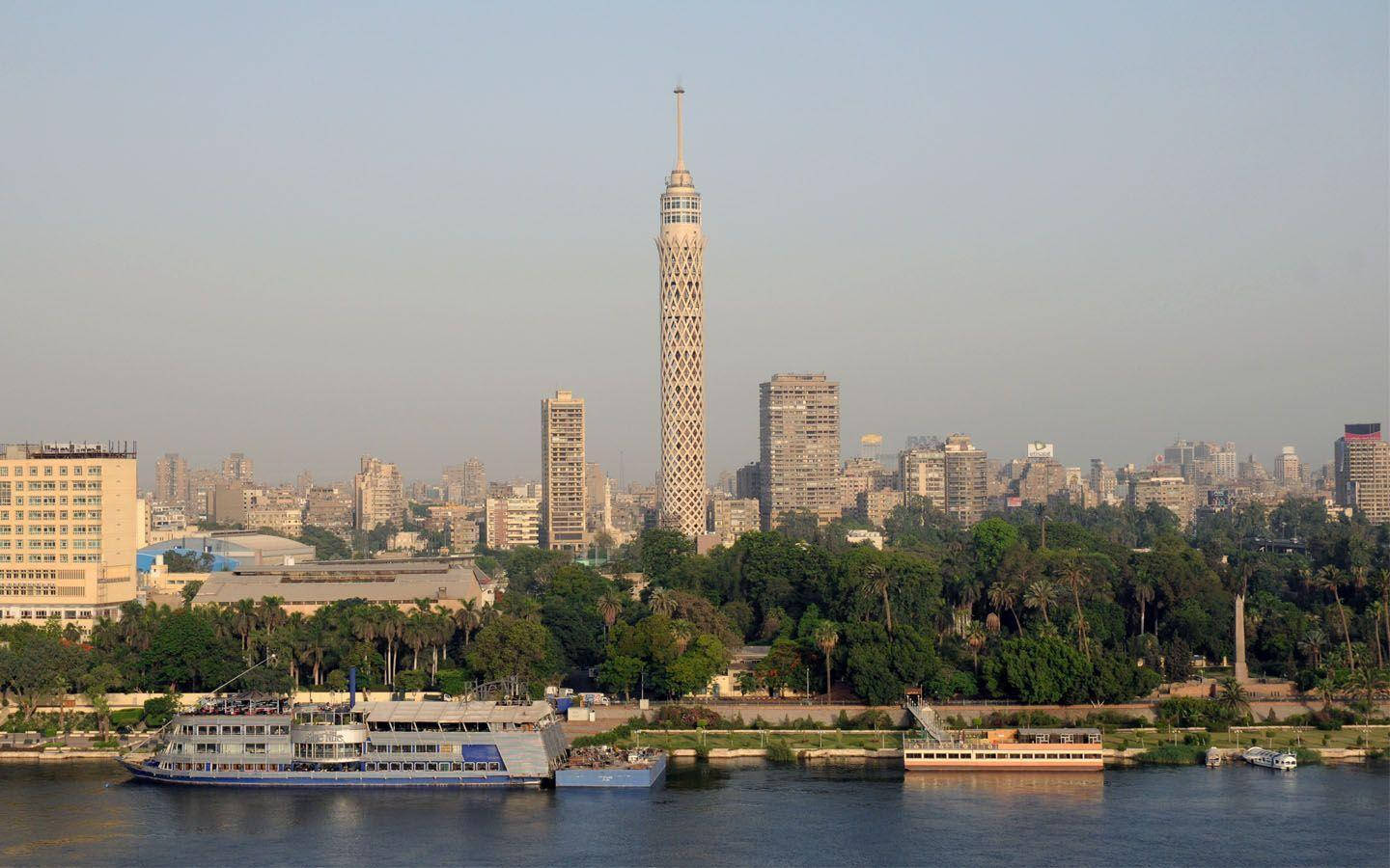 Cairo Tower With Blue Nile Boat Background